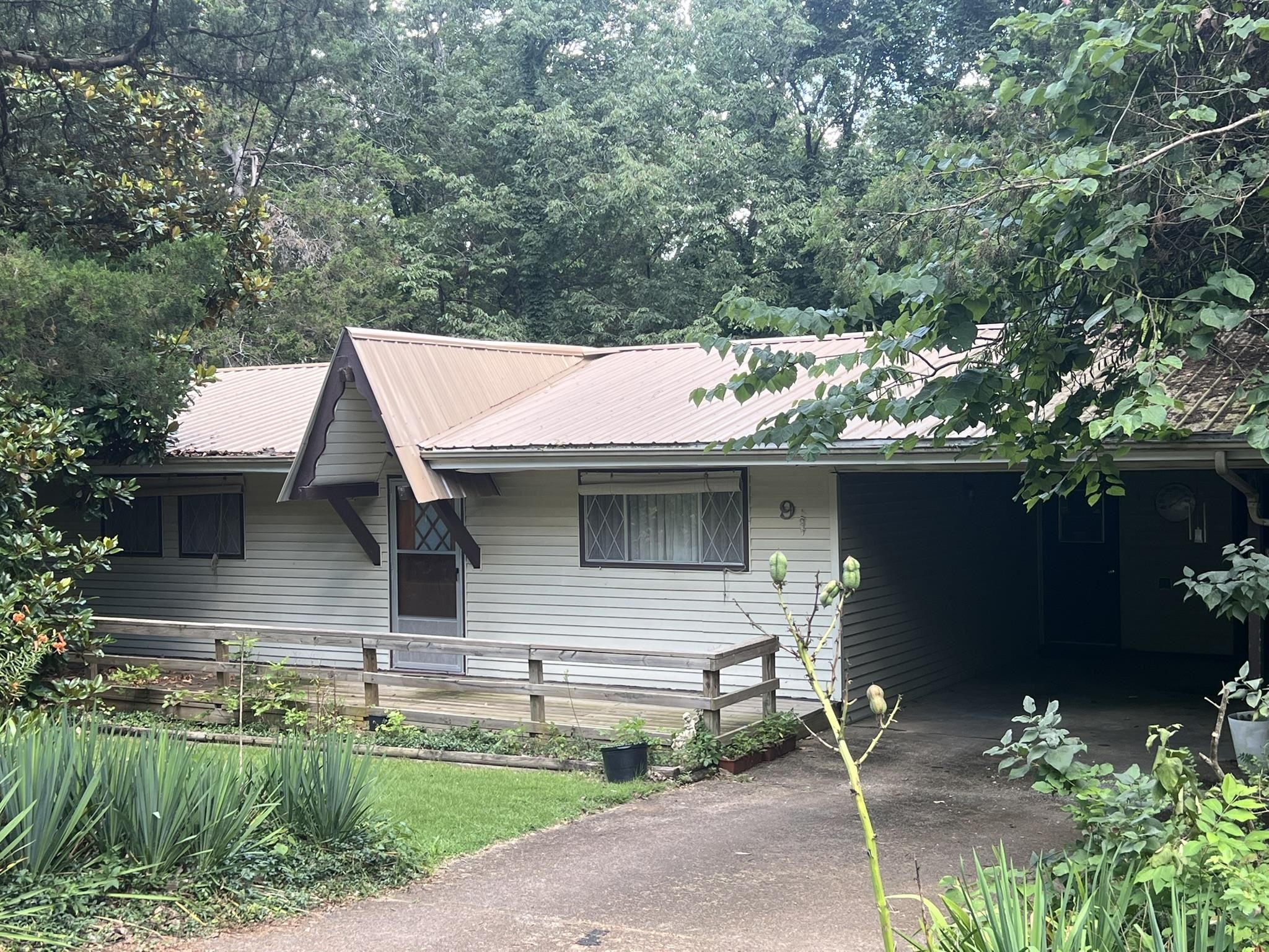 This charming well maintained 2 bedroom cottage is ready for a new owner. It features an open concept vaulted kitchen, living & dining room. There is a separate laundry room, single carport and a covered patio to enjoy the natural wooded area surrounding the home. Back lawn slopes gently toward the beautiful wooded setting. Kitchen has plenty of counterspace and cabinetry. Bathroom has been updated. This gem is priced right to sell; it won't last long at this listed price.