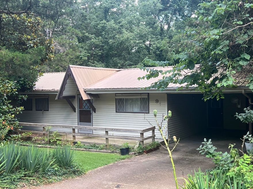 This charming well maintained 2 bedroom cottage is ready for a new owner. It features an open concept vaulted kitchen, living & dining room.  There is a separate laundry room, single carport and a covered patio to enjoy the natural wooded area surrounding the home. Back lawn slopes gently toward the beautiful wooded setting. Kitchen has plenty of counterspace and cabinetry.  Bathroom has been updated. This gem is priced right to sell; it won't last long at this listed price.