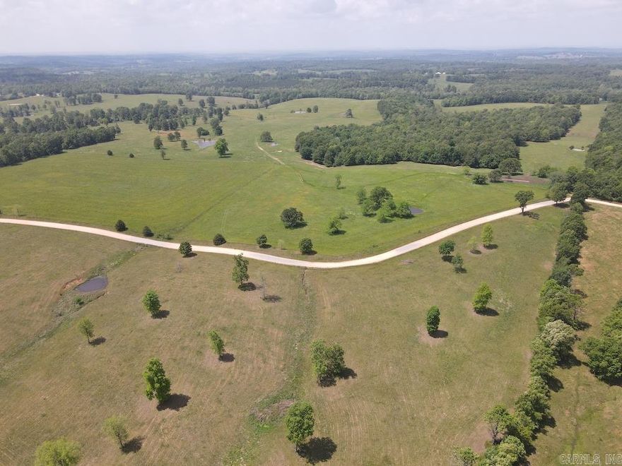 Stunning, in every sense of the word… this amazing tract truly embodies “Stunning”! For over four decades, this property has been managed intensely for hay production and livestock. Located between Mountain Home, AR, and Salem, AR, logistics are ideal for that perfect balance of convenience and privacy. The gravel county road cuts along one side of the land and offers terrific access. Electricity comes right to the gate, and with a recently approved easement for rural water, you will soon have no obstacles to setting your dream home in one special place. Currently, the tenant has a steer operation rotating them on the phenomenal pastures and temporary working facilities positioned right off the road for ease of movement and loading. This level area is very close to a pond and would be ideal for a permanent livestock working facility. The perimeter and interior fencing are in excellent condition and ready to house virtually any livestock you choose. The pastures consist of a wonderful mix of native warm and cool season grasses along with Bermuda and fescue grasses.