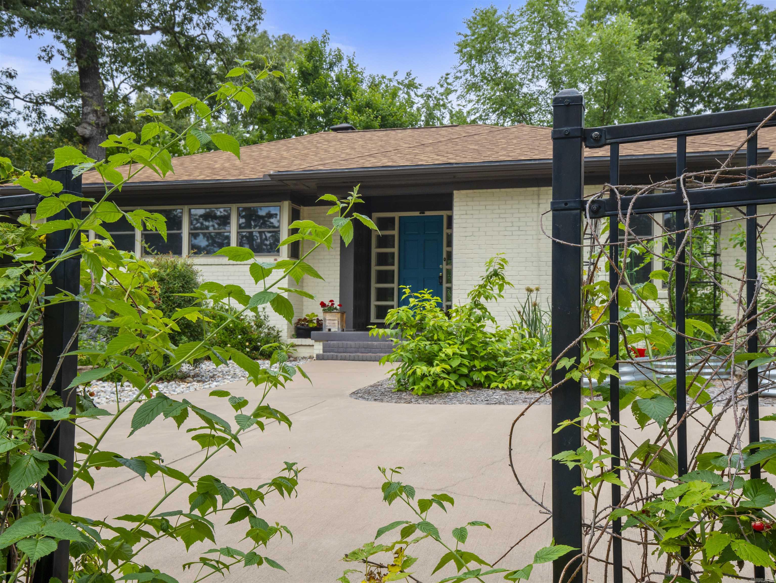 What a house! Mid Century Modern with quality renovations on a desirable Street in Uptown. Nature abounds in this space (.83 acre). Gardeners will love the gardening shed and greenhouse to accommodate the mature gardens this seller has put in. Back deck placed in the middle to view the gardens and watch the birds. Seller has downsized, the love for the home shows through. Dynamite kitchen with view windows and huge working Island. Built in's in dining room and office bedroom. Double sided fireplace from living room to dining room. ALL NEW WINDOWS 2025. Roof replaced 2024. This is a beauty, don't miss!