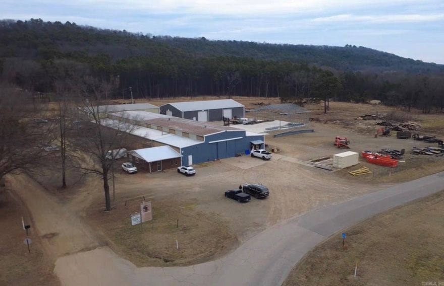 This expansive commercial offering sits on 10.5 acres in a highly visible and convenient location just off Interstate 40, providing excellent accessibility for logistics, manufacturing, or industrial operations.  The property features two substantial shop buildings designed for heavy use and efficiency:  • Main shop: 18,880 sq. ft.  • Second shop: 6,000 sq. ft.  • Overhead cranes already installed  • Mounted space heaters throughout  Office and employee amenities are thoughtfully laid out and well equipped, including:  • Main employee bath with 1 shower, 1 toilet, and 2 urinals  • Separate men’s and women’s restrooms in the office area  • Full private bath located in the main office  This property offers two purchase options, allowing flexibility for investors or owner-operators.  Call today!!