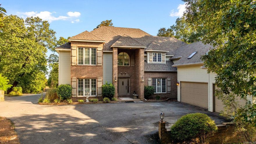 This spacious and elegant home offers two large living rooms, perfect for entertaining or creating separate relaxation spaces. With a bit of clearing, you could unlock breathtaking views from this peaceful retreat. Features include: 2 gas log fireplaces, 3 car garage, grand entryway with a spiral and formal staircase. Beautiful hardwood floors. Expansive kitchen with large island and pantry. Three full bathrooms plus a half bath. Bonus room, ideal for a home office, gym or playroom. Built-ins in the living room. Large deck, perfect for outdoor entertaining or relaxing. Abundant closet and storage space throughout. This home was custom built by the owner. Attention to detail and quality of construction went into this home from the start. Set on 3.39 acres of tree shaded land in a quiet established neighborhood. Private setting.  This home blends luxury with privacy and space. Roof 5 years old. 220 amp service in garage. Refrigerator and Bar refrigerator stay.  A rare find!