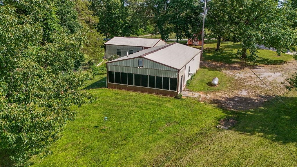 Outdoor lovers, this is your dream getaway! Just steps from Lake Charles, this one-of-a-kind shop house sits on 3 +/- acres of mature shade trees with beautiful fall and winter views of the water. The full-length screened front porch is the perfect place to unwind after a day on the lake or in the woods. With 2 bedrooms, 2 full baths, and a flexible bonus space (great for a small 3rd bedroom, office, or gear room), the current setup sleeps up to 12—ideal for a hunting or fishing lodge. The fenced side yard with doggy door makes it perfect for bringing your four-legged hunting buddy. Located less than a mile from Shirey Bay Rainey Brake WMA—featuring over 11,000 acres of prime duck and deer hunting—and minutes to world-class bass fishing, boating, and hiking at Lake Charles. The spacious 30x30 attached garage is ideal for parking or boat storage. You'll also appreciate the 16x25 barn/shed—perfect for storing tools, gear, or outdoor equipment. This is the ultimate basecamp for the serious outdoorsman. With its unique setup and location, it would also make a fantastic short-term rental. All this just 30 miles from Jonesboro, 24 miles from Hardy, and 35 miles from Batesville.