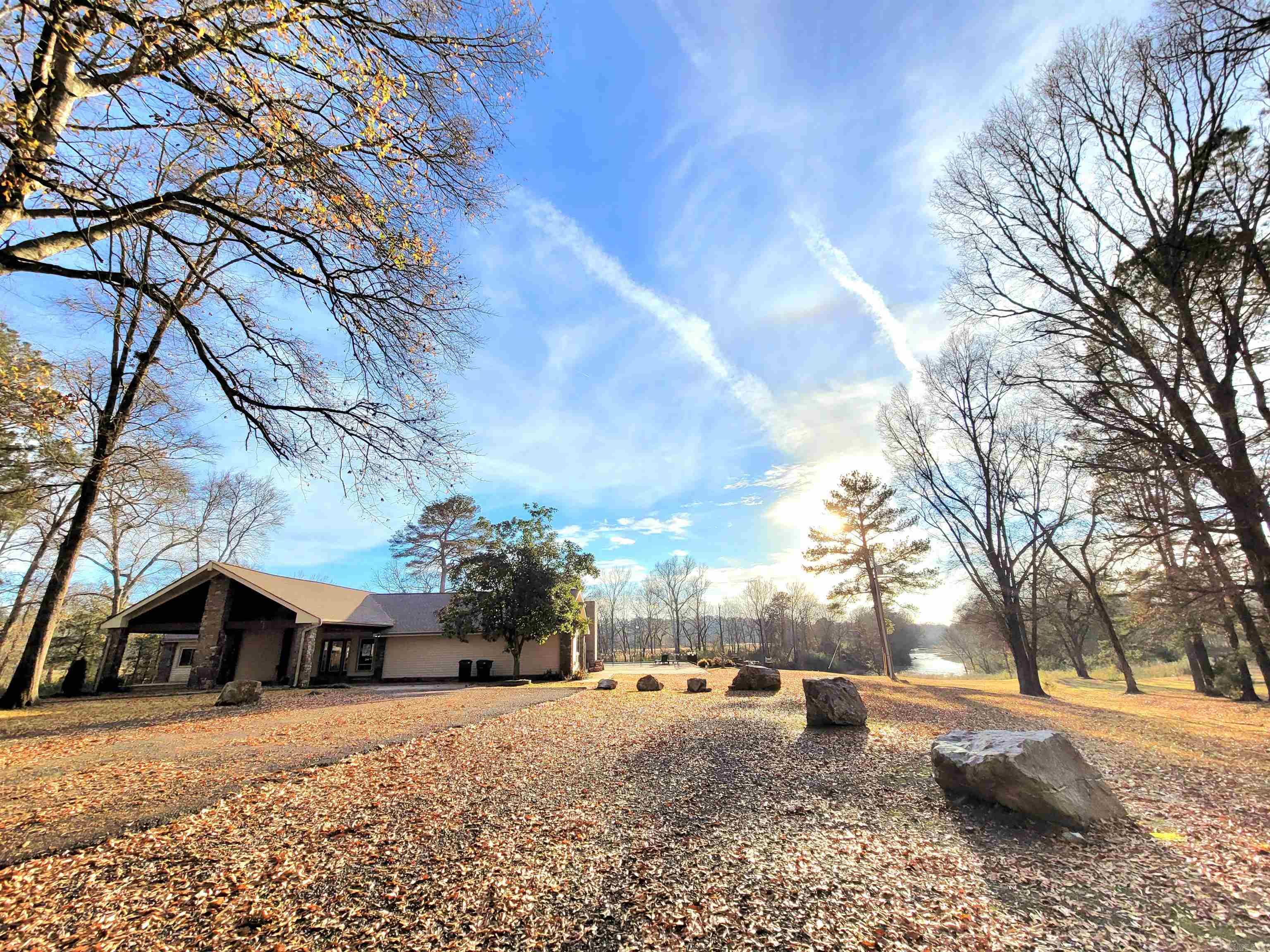 Sanctuary on the River! Welcome to the Lodge! These sprawling 8+ acres, which are nestled right on Kelly Creek, are the perfect mix country living with a touch of modern amenities. The property features a 3/1 cabin, as well as a barn used as a game room/bar area. This is the perfect family getaway that features a private sauna, inground pool, a huge covered patio with outdoor fireplace, an outdoor gaming building for events, and a kitchen large enough for all the in-laws! Have your guest kayaking on the river, holding events in the barn which has a full bar and pool/poker table, or just making memories for a lifetime, and all while adding a second income to your pocketbook! The 2022 financials for this STR show a gross income of $165k (limited bookings in 2023 by new owner)! There is the added potential to split off some acreage in front of the cabin and barn and sell lots, or build some spec houses! Home comes fully furnished to start your business the day after closing. The owner will transfer any scheduled bookings upon closing. Don't miss this great opportunity for a large Airbnb on the water! Call us today to schedule your tour!