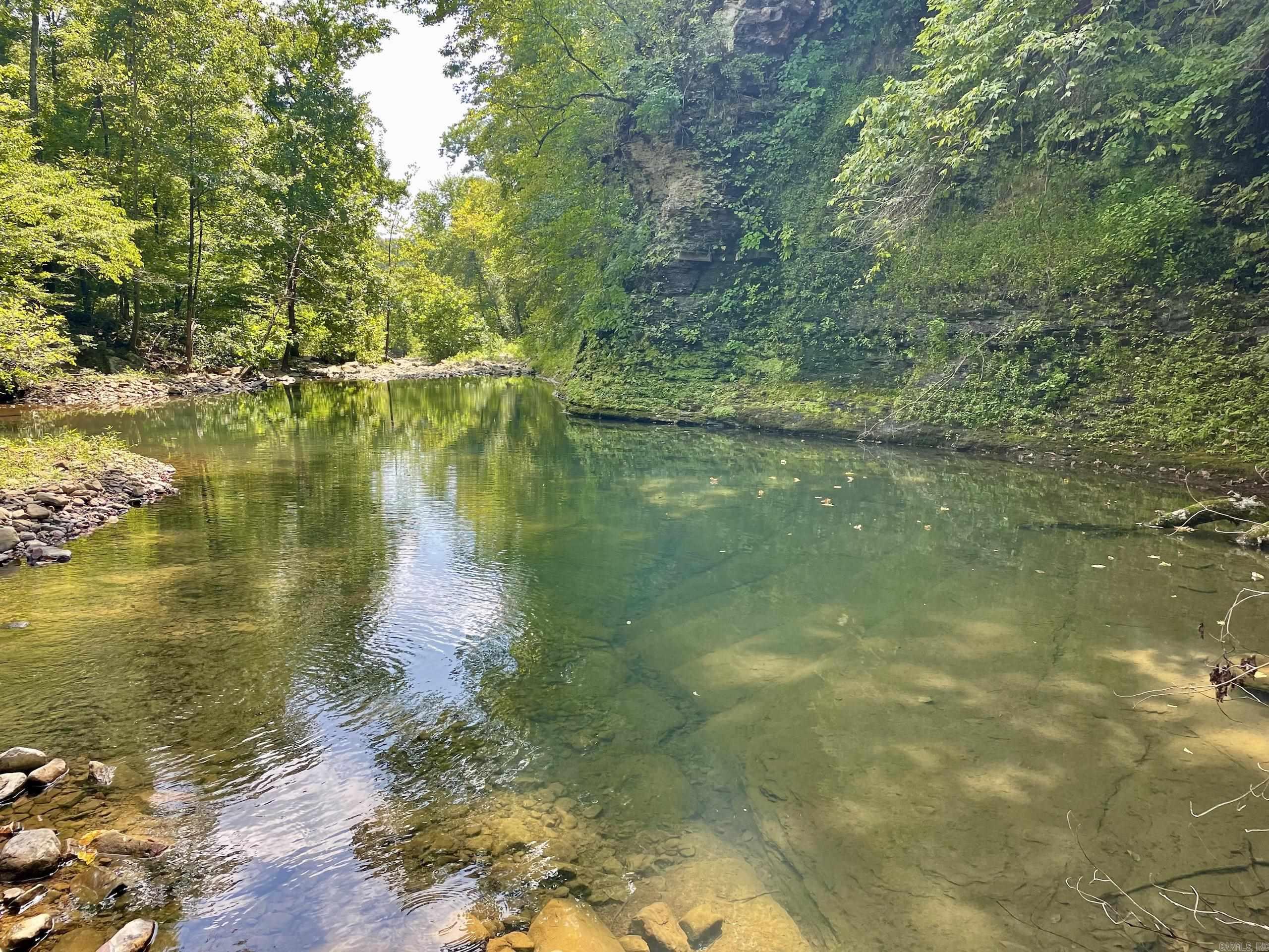 Tucked deep in the heart of the Ozark Mountains, this completely off-grid property is a hidden gem for those seeking true seclusion and natural beauty. Though rugged and remote, a logging road leads to the property, making it accessible by four-wheel drive, especially to the banks of the stunning Archey Creek. With over 1,000 feet of year-round creek frontage, youāll enjoy wading pools, bubbling rapids, and a breathtaking swimming hole framed by a shaded bluff on one side and a peaceful gravel bar on the other. It is Ideal for picnics, camping, fishing, or just unplugging with family and friends. Smallmouth bass and a variety of panfish make this a great spot for anglers. Surrounded by mature hardwoods and teeming with wildlife - deer, turkey, and even black bear - this land offers multiple building sites perfect for a rustic cabin or seasonal getaway. Scattered cabins along the creek hint at a quiet, like-minded community nestled in the wilderness. Please note: while there is a road to the property, it is privately maintained and does not currently offer legal access.