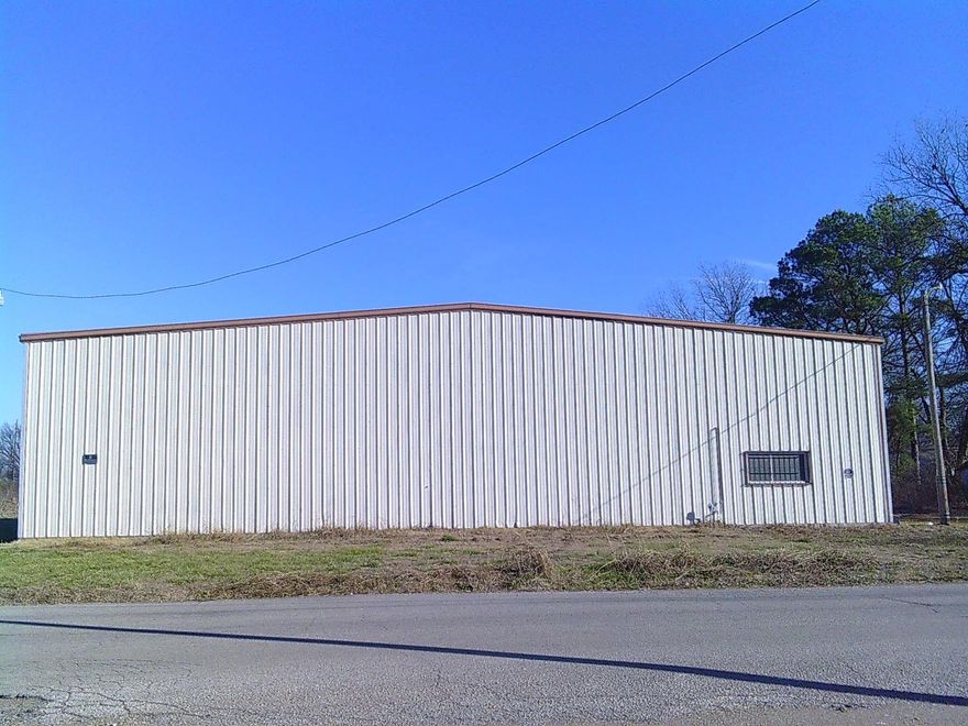 Versatile 4,000 SF Shop with 20’ Sidewalls & Office Space Discover a prime opportunity in Blytheville! This exceptionally commercial shop building features impressive 20-foot sidewalls, perfect for high-stacking storage or large equipment. The interior boasts a solid concrete floor in great condition and a functional layout that includes a dedicated front office and two bathrooms. Enjoy the added value of upstairs storage to maximize your square footage. Exterior features include a professional walk-in door and a large overhead door for easy bay access. Situated on a clean, level lot, this building is move-in ready for your business or investment portfolio.