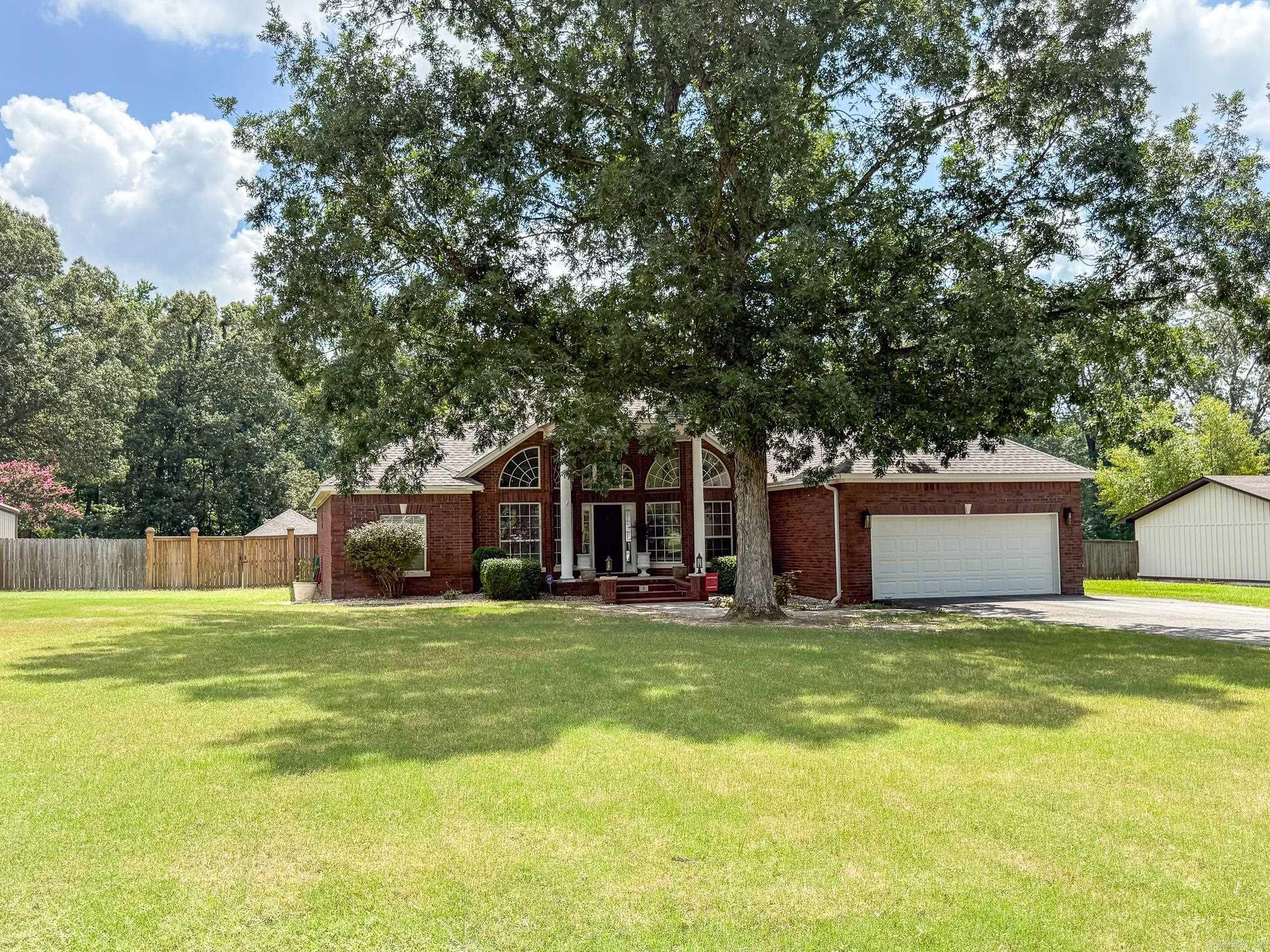 Welcome to 9 Kings Road, Cabot, AR, a beautifully remodeled home that combines modern convenience with timeless elegance. This residence boasts a new roof installed in August 2023, ensuring lasting protection and peace of mind. The property features an impressive 18 x 36 in-ground pool with a new liner added in September 2021, perfect for leisurely swims or entertaining guests. Completely remodeled in 2020, the home offers new luxury vinyl flooring throughout, stylish bathroom remodels, and elegant granite countertops. Enjoy cozy evenings by the wood-burning fireplace in the den, and appreciate the custom tile showers that add a touch of luxury to your daily routine. The kitchen is a chef's delight with a charming brick backsplash and a distinctive wood vent hood. Additional amenities include an extra double garage/shop, a new asphalt driveway with additional parking added in 2024, and expansive backyard space providing privacy and tranquility. Sunlight streams through the charming windows, infusing the home with natural light and warmth. The backyard boasts a beautiful tree line beyond the back privacy fence that won't be developed! Call today to schedule your showing!