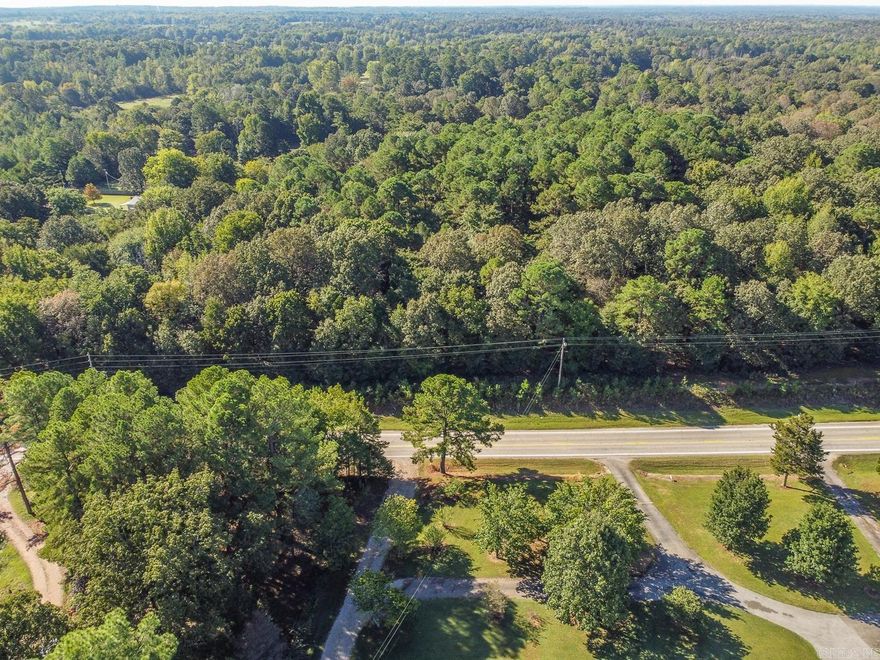 Wooded 4-acre tract with paved highway frontage in Greene County Tech School District. This property offers mature trees, sloping topography, and multiple potential building sites. City water and electric are available at Hwy 358 frontage (buyer to verify provider and connections). No septic system is currently installed. Includes an old frame structure and small shed, both sold at no value. Excellent opportunity for future development or residential use—call today to make this property yours!