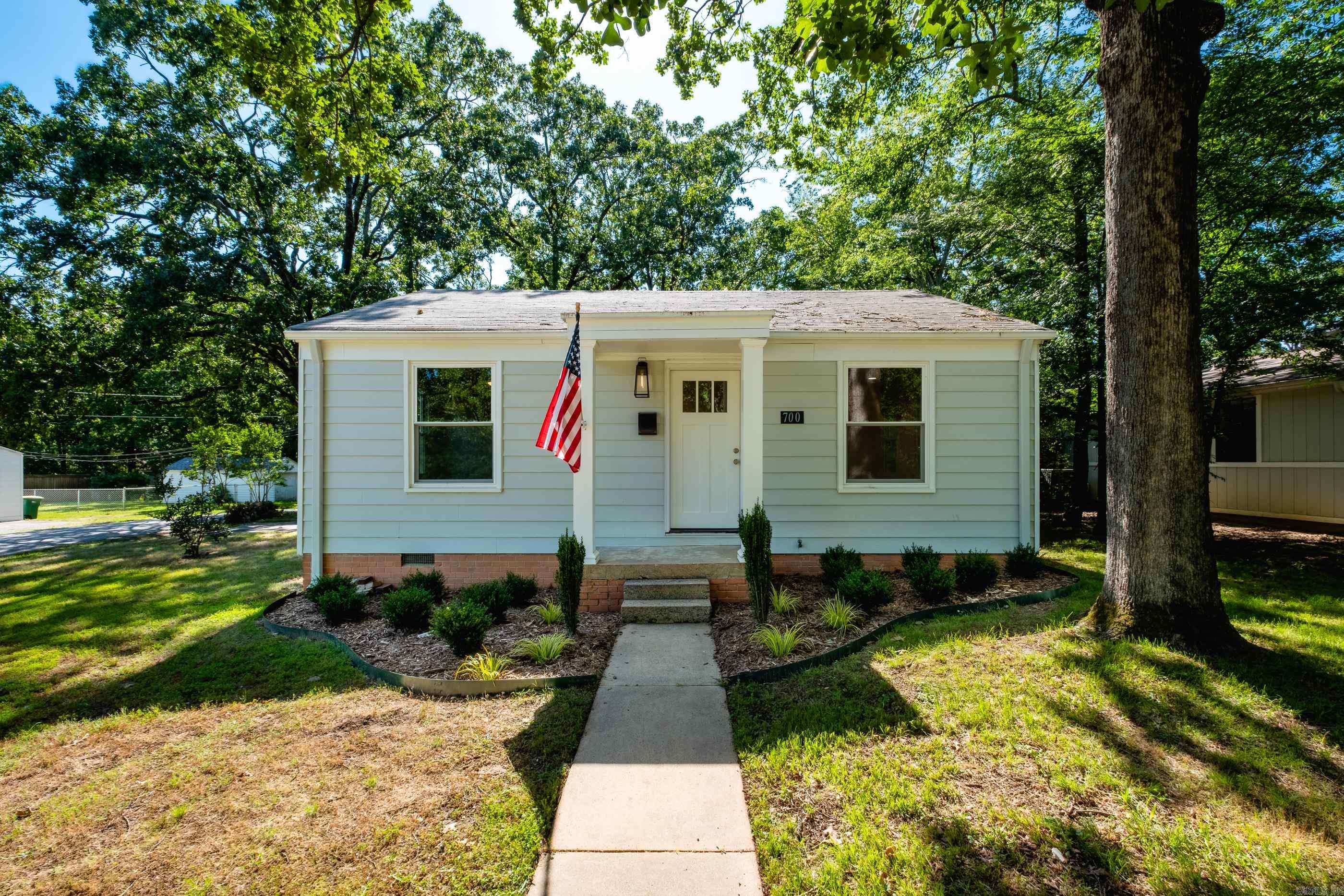 Location is everything, and this newly renovated Hillcrest home delivers with a large corner lot on a quiet, low traffic street. This home features an open design with a split bedroom floorplan creating privacy for the primary suite. Gleaming hardwood floors welcome you throughout the living space. The kitchen features gorgeous stone countertops and new stainless steel appliances. The laundry is conveniently located off the kitchen and doubles as a walk-in pantry space. The primary bedroom suite includes a renovated bathroom and a great walk-in-closet. Enjoy evenings on the patio with a large, fully fenced backyard. Off street parking provides easy access to the kitchen door, and there is plenty of room on this lot for a carport or garage. Newer windows were previously replaced. Hillcrest amenities, UAMS, and schools are just a short bike ride away. Priced well below recent appraisal. This is home!