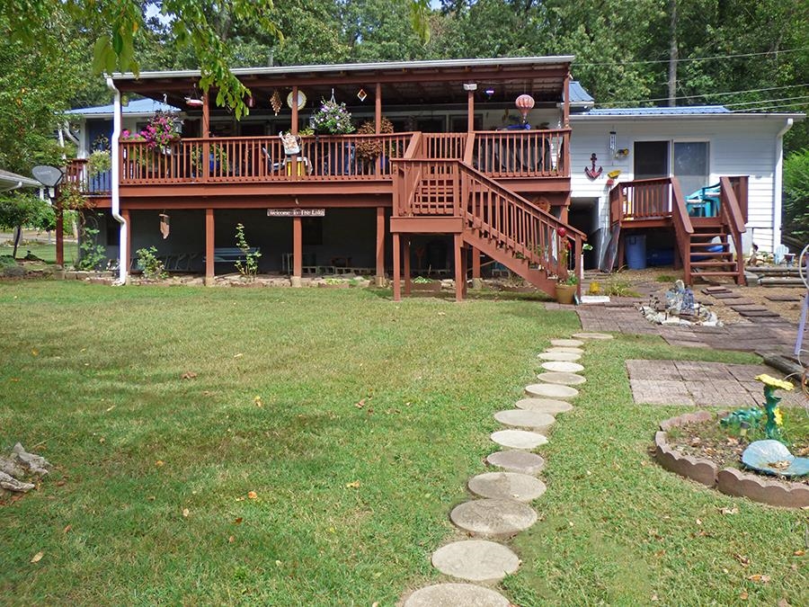 Looking for a beautiful lakefront home? See this one! Located on Lake Sequoyah on a great lot. It features 5 bedrooms, 1 & 3/4 baths, approximately 2,056 square feet of living space with central heat & air plus wood burning stove. Metal roof new in 2023, garage, plus a large back covered deck that overlooks the lake. Home also features a beam ceiling, 4 skylights, a full back sun room that has a wonderful lake view, updated appliances, newer water heater and floors were done in 2019. This is a must see house!! Great Lakefront Living!!