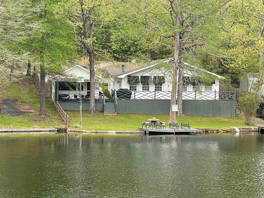 One of the best lots on Lake Norrell. It is flat! Lots of updates including new central  heat and air. Features 3BR 2 1/2BA with covered deck and screened porch. There is a deck all the way across the back with beautiful view of the lake and large backyard. Must see. Owner is licensed real estate agent.