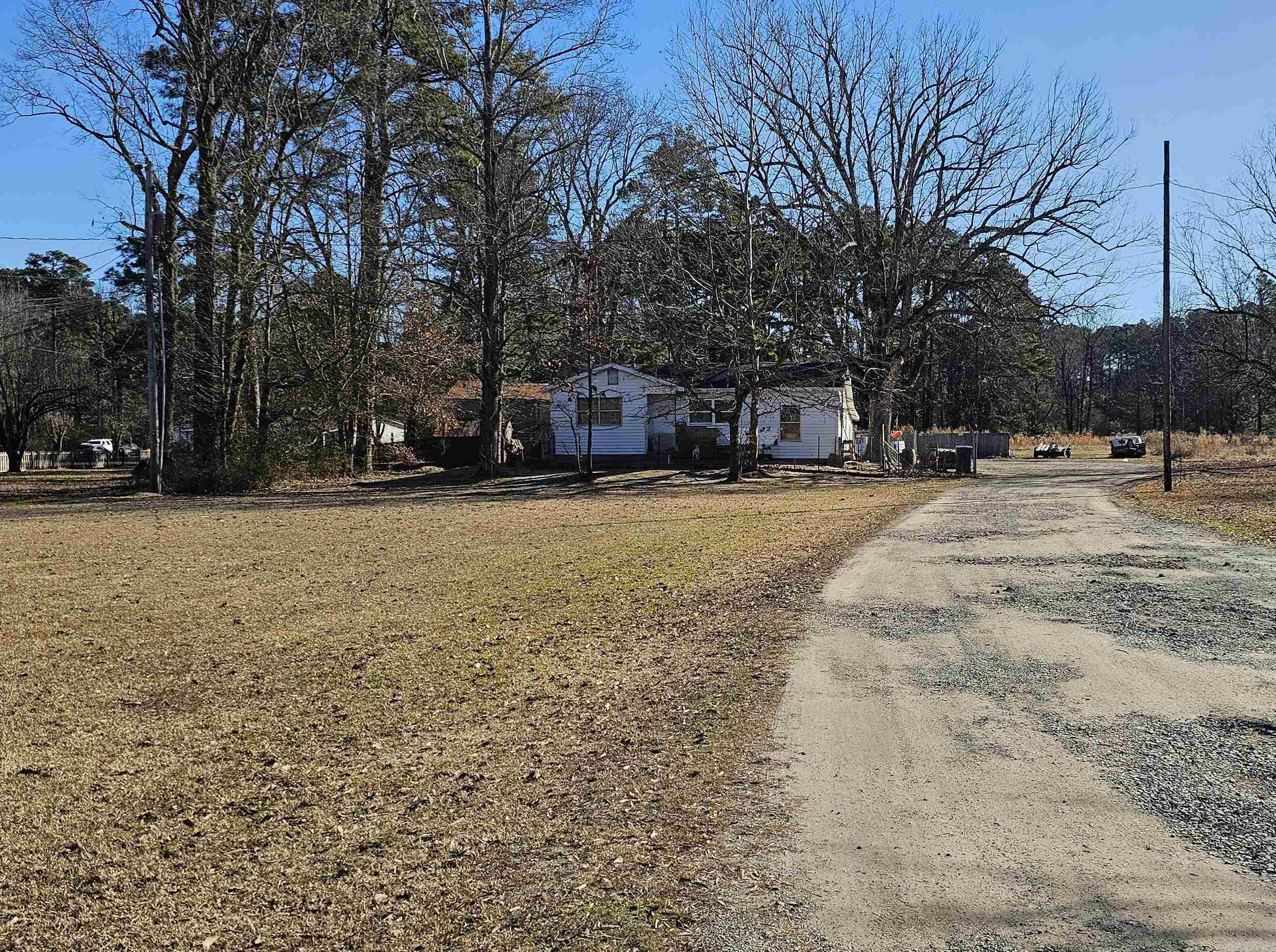 Great place for investor or someone looking for a fixer upper! 2.5 acres right outside of White Hall city limits. Property includes a 4-bed home, a large shop, and extra lot for mobile home. Back lot has additional septic tank and electric service already installed. Call Listing agent to view property!