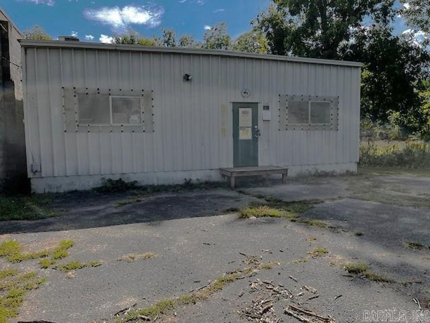 Red Iron Metal building insulated and central station alarmed. 864 sf Heated and cooled, plus 9x18 loading dock and 9x18 unheated space in rear.  Interior has larger finished display reception room and smaller private office space. Half bath in rear warehouse space.  Additional storage over interior framed space.  Rear yard includes additional concrete slab at grade level and is accessible from both 33rd Street and the alley. Appointment required.