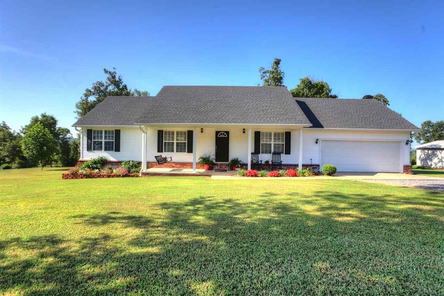 Country Charmer! If you'd like to get back to quiet this 3 bed, 2 bath home is just what you've been looking for. Front porch for rocking, roomy kitchen, bright and cheery living room. Store your boat or ATVs under the extra covered parking. Sit on the back deck and enjoy the view. Fully fenced bring your dog. Call today for an  appointment.