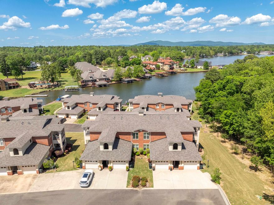 Come check out one of the larger lake condos with a one car garage that Lake Hamilton has to offer. This gated complex with a wooded area on one side of the condo has a country feel yet is close to everything you may need. This upper unit has a large balcony with Lake Hamilton views. The condo offers a Bruno chair lift for you or your groceries, fairly new HVAC (2021), recent interior paint, newly painted front stairs and back/side deck floor and rails. The master suite has built in shelving, a fireplace, a super large Jacuzzi tub, a walk-in shower, multiple cabinets, and a large walk-in closet. This open floor plan is great for cooking in the gourmet kitchen and for entertaining in the spacious living dining areas. This complex offers a private boat ramp and boat tie ups.