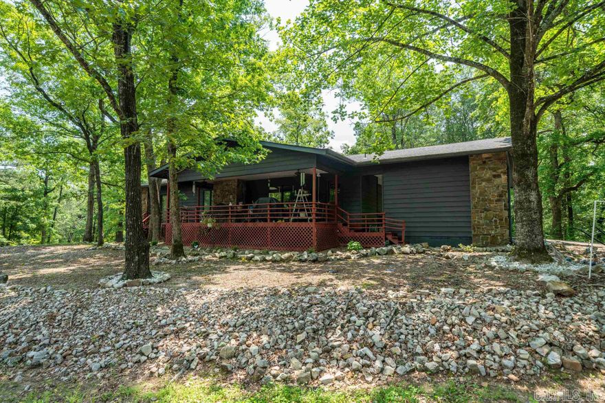 Welcome to this inviting 3 bedroom 3 bath home nesteled in the desireable community of the Hot Springs Village. Rustic features like beamed ceiling, wood paneling, stone fireplace give this home a cozy and earthy appeal. This charming home offers a spacious covered deck, 2 car carport, 1 car garage and bonus room with it's own bathroom downstairs that can be easily converted to another bedroom or in law quarters and is situated on a large corner lot.  Hot Springs Village is renowned for its stunning natural surroundings and offers an array of recreational activies such as golfing, hiking, boating and fishing and has a variety of amenities including pools, tennis courts fitness centers and social clubs.  Don't miss your opportunity to own this unique home!