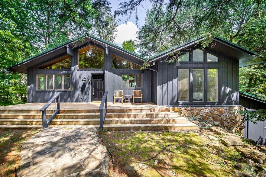 So much to offer!! Fully Furnished Lakefront Cabin with steps in your backyard right to TWO Boat Slips, TWO boat lifts, One Jetski Pad, plus home has a lake view (more trees can be cut to open up the view)!!! Newly re-finished hardwood floors, brand new upstairs HVAC unit, new refrigerator, washer and dryer, and newly painted exterior.  (sellers clothes, flower pics in upstairs bedroom, cream lamp, Boats & Jetski do not convey, but everything else stays). TPOA has tennis courts, playground, volleyball court, & covered party pavillion w/outdoor stone fireplace available for property owners & your guests to use. Each bedroom is setup like a master suite, so all 4 bedrooms have their own full bathroom which your company will appreciate!! Tons of deck space for entertaining. This home will also include your own Prim Round Rock which are very unique rocks & add a cool touch to the property.