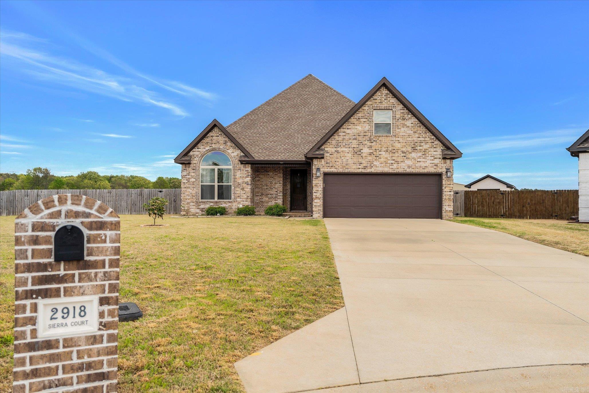 Welcome Home to 2918 Sierra Ct. located in Jonesboro, AR in Valley View School District. This 4 bedroom, 2-bath home offers 2398 sq ft of thoughtfully designed living space situated on .36 acre lot located at the end of a cul-de-sac. Upon entering through the front door you will be greeted by an open concept main living area with beautiful luxury vinyl plank flooring throughout, tall ceilings, gas fireplace, and an abundance of windows allowing natural light to flow through the home. The kitchen is conveniently located off of the main living area. It features quartz counter tops, stainless steel appliances, breakfast bar, and an eat in dining room. The primary suite is split from the two additional bedrooms on the main level. The primary suite features a large bedroom with tray ceilings and access to the primary bath. The primary bathroom offers a double vanity, beautiful walk-in tile shower, soaker tub, and a large walk-in closet. The two additional main floor bedrooms are located adjacent to the main floor 2nd bathroom. Upstairs you will find the 4th bedroom that offers endless possibilities. This home has everything you have been waiting for. Schedule your showing TODAY!