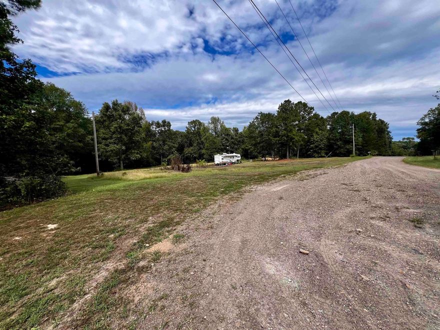 In Kirby, not far off of Hwy 70 is 9.3 +/- acres with utilities on site and ready to be established. The property has wooded acreage with a combination of hardwood and pines. There are no restrictions on this land so you can do with it as you please. Developers, this is a must see as there is potential for subdividing and creating multiple homesites. This is just a few short miles to beautiful Lake Greeson and the Caddo River. This is a must see! The camper does not convey and will be moved before closing. Call for a showing soon!