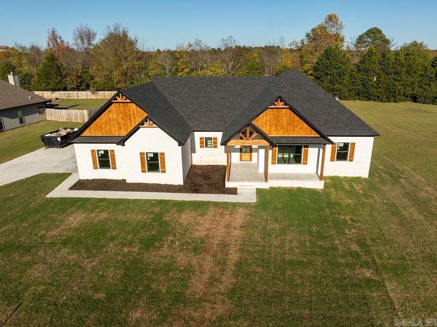 This property is located across the street from Greers Ferry Lake in beautiful Emerald Isle subdivision.  Features include: luxury vinyl flooring, SS appliances, granite countertops throughout, stained trusses in main living area and outdoor kitchen area made of cedar.  Additional features include, tankless WH, walk-in shower in primary bath with rainhead, large walk-in closet, mud-room off laundry with half bath and large walk-in pantry.  Lake access off El Camino Real or launch at Shiloh Rec area just minutes from the house.  Lake season is just around the corner and this would make a wonderful lakehouse!!