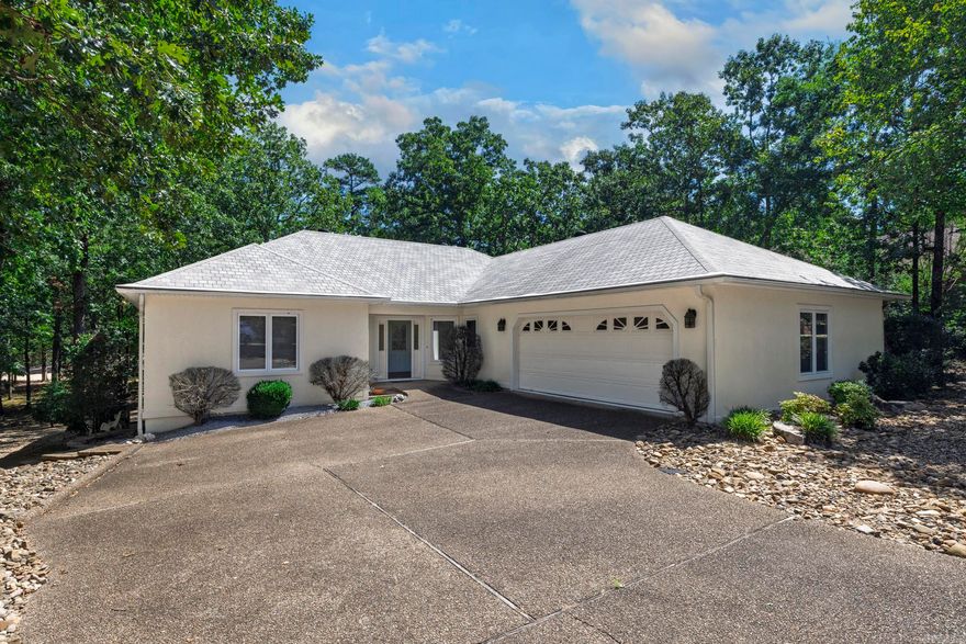 Nestled in the serene and highly sought-after Hot Springs Village, this immaculate and meticulously maintained home offers the perfect blend of comfort, style, and convenience. Just a few doors down from the expansive and amenity-rich Lake Balboa, this property presents an unparalleled opportunity for the discerning buyer.  Step inside to discover a thoughtfully designed 3BR/2B split floor plan, offering exceptional privacy for residents and guests alike. The large LR is bathed in natural light, enhanced by two strategically placed skylights, creating an inviting and airy atmosphere. Beyond the living room, you'll find a delightful Arkansas Room, providing additional flexible living space perfect for relaxation, a home office, or a sunlit hobby area. Large, beautiful windows throughout the home frame picturesque views. Step out onto the spacious deck, an ideal spot for enjoying your morning coffee, al fresco dining, or simply soaking in the tranquility of the lush landscaping. This truly move-in ready home comes complete with a refrigerator, washer, and dryer, granite countertops, and oversized garage (2+)!  Call today for your private tour!!