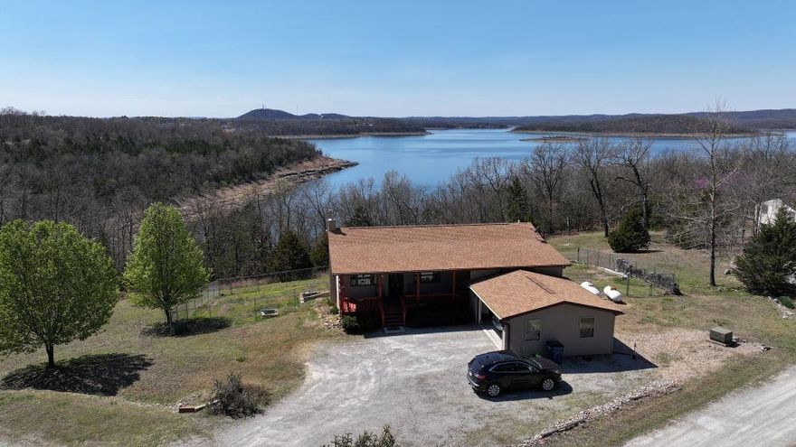 LOOKING FOR A HOME WITH A VIEW AND A BOAT SLIP? THIS IS IT! 2 BED, 2.5 BATH HOME BORDERING THE GOV’T CORPS, WITH A YEAR-ROUND VIEW OF BULL SHOALS LAKE AND A BOAT SLIP WITH LIFT.  BUILT IN 2009, THIS HOME HAS CUSTOM HICKORY CABINETS, LAMINATE FLOORS, 36”- 6 PANEL WOOD DOORS, TILT WINDOWS, GUTTERS, ATTIC FAN AND A WHOLE HOUSE GENERATOR TO NAME A FEW HIGHLIGHTS. BOTH BEDROOMS ARE EN-SUITE, ONE BEDROOM UPSTAIRS AND ONE DOWNSTAIRS FOR PRIVACY.  WOOD STOVE IN WALK OUT BASEMENT, WHICH HAS 9’ CEILINGS, STAINED CONCRETE FLOORS AND IS PARTIALLY FINISHED. HANDICAP ENTRANCE TO MAIN FLOOR. THE HOME HAS A 2022 ROOF, 2009 HVAC, 2 CAR GARAGE WITH BREEZEWAY TO HOME. 6’ CHAIN LINK IN YARD FOR FURRY FRIENDS. THIS HOME IS ABSOLUTELY MOVE IN READY, JUST IN TIME FOR BOATING SEASON.