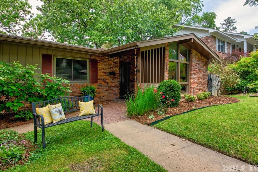 On a tucked away Midtown street, on an amazing lot, sits this darling ranch-meets-mid-century modern home. Multiple living areas allow space for everyone to enjoy his or her own "hang out" spot. The bedrooms and main living space are located on the first floor. Office (or 4th bedroom), family room, and a huge heated/cooled workshop space (additional 303sf) are extra special "living space" downstairs. Don't miss the beautiful backyard! A deck perfectly sized for your grilling delights overlooks the incredible backyard with a brick patio perfect for a fire-pit, a terrific play-set and an extra fun custom-built treehouse. Enjoy the original, lovely hardwoods and light-filled windows, updated features like newer windows, AC, roof and board and batten insulated siding.   Play set and treehouse both stay. AGENTS, see Remarks.