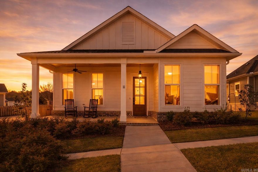 Southern Living, but elevated.  This 3-bedroom, 2 bath home blends timeless charm with a designer curated aesthetic that feels straight out of a magazine. From the moment you step onto the inviting front porch, you know this one is different.  Inside, every detail has been thoughtfully selected. A light filled open layout, warm wood tones, custom cabinetry, and a statement kitchen with high end appliances and a stunning natural stone backsplash create a space that is both functional and beautiful. The living area centers around a textured fireplace, while the spa like primary suite features a freestanding soaking tub, dual vanities, an expansive walk-in shower, and a generous walk-in closet.  Additional highlights include a dedicated pantry, custom storage throughout, and elevated lighting selections that tie everything together.  And then there is the lifestyle. Just steps from the community pool, with a neighborhood farmers market also within walking distance.  Polished. Intentional. Completely move in ready.