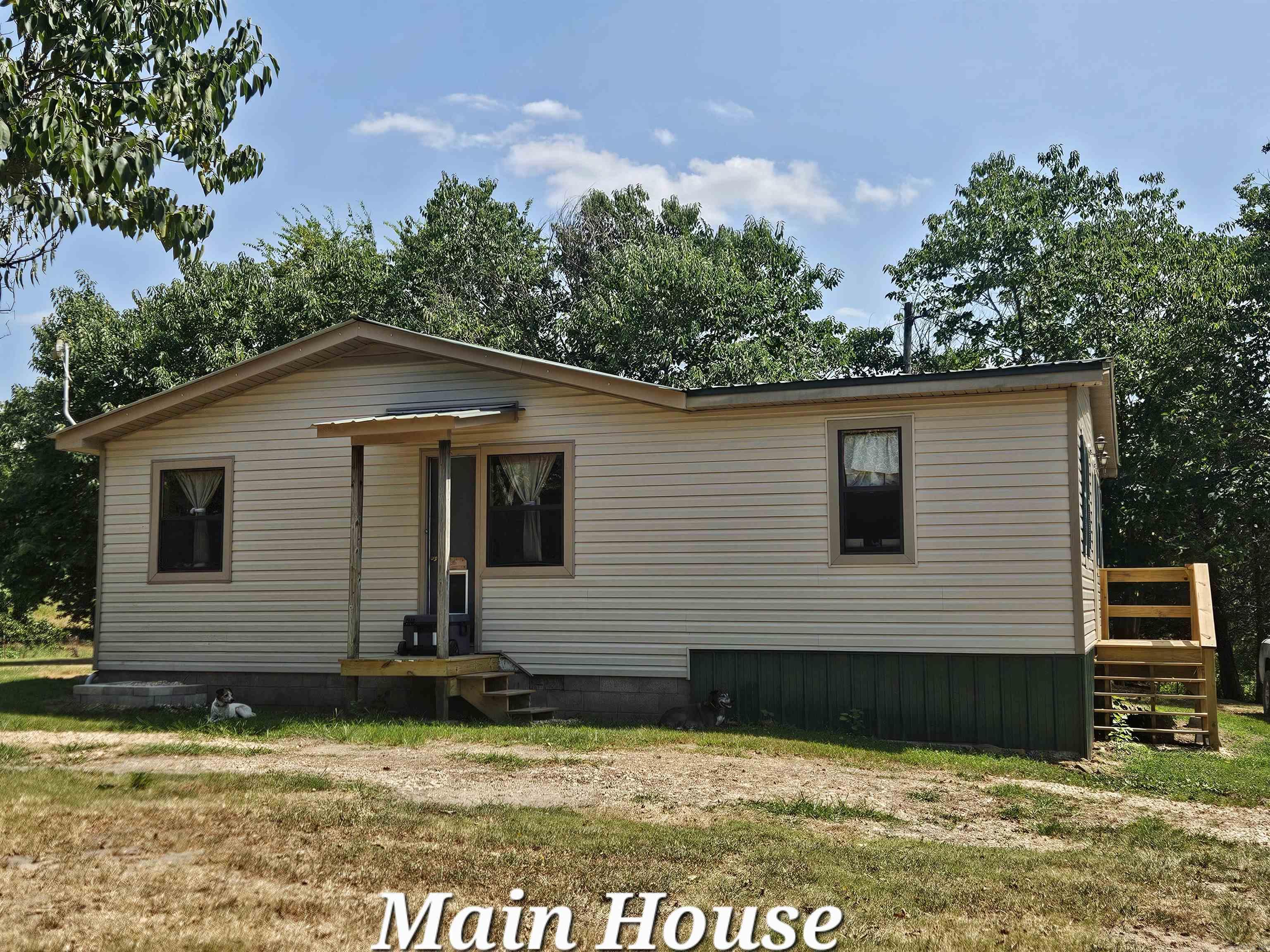 TWO VERY NICE HOMES, YEAR-ROUND SPRING FED STREAM FLOWS THRU PROPERTY, 5 ACRE MINI-FARM READY TO FARM, OPEN PASTURES, MOSTLY FENCED, PRIVATE, SECLUDED, NO RESTRICTIONS, 15 MINS TO TOWN, 1.9 mile of dirt road, 18 MINS TO BUFFALO NATIONAL RIVER where your family will enjoy hiking, paddling, fishing, camping, & stunning views. HUNTING IS LEGAL, SMALL & LARGE GAME HERE, ENJOY PEACE, QUIET, BREATHTAKING MOUNTAIN VIEWS, FIBER INTERNET, 36x30 WORK SHOP W/WOOD STOVE, perfect for projects & storage, STORM CELLAR, WELL & CITY WATER, GORGEOUS VIEWS 360 DEGREES The newer home is 800 sqft, has wood heat, a propane heater, & a new septic, 1 bath & wood-siding with a metal roof. The main home has 1,296 sqft, 3 bedrooms, 1 bath, vinyl siding, metal roof, new mini-split, place for wood heater, & septic. It's a perfect place to raise a family, livestock, & produce your own food. It provides solitude, & nearby adventures on the river. Whether you're looking for a multi-family setup, hobby farm, or a private retreat, with potential income as a rental or nightly rental by the river this Ozark's gem has it all! Donāt missācall today for a showing! Owners retiring & moving the city!