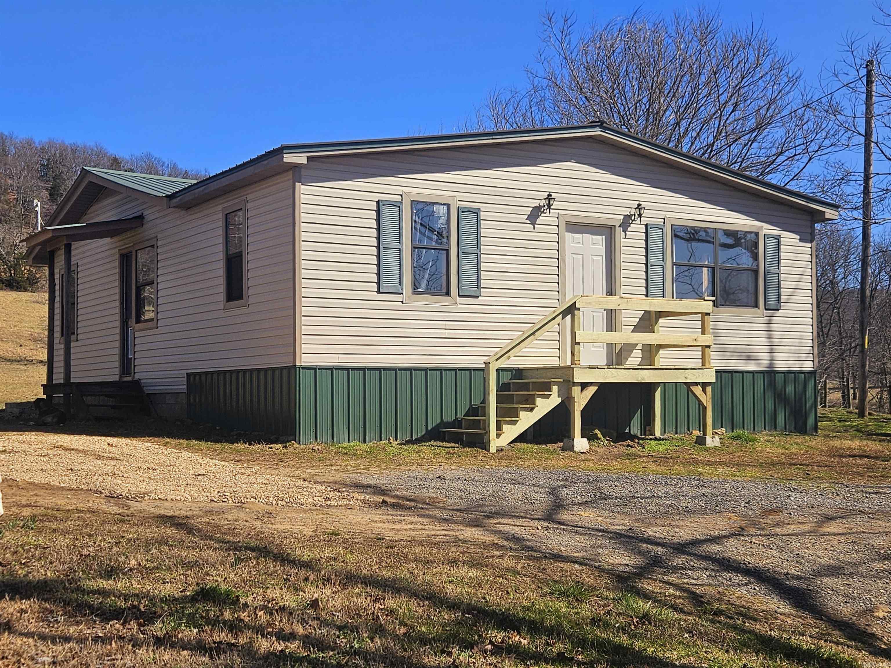 Sale includes TWO BEAUTIFUL HOMES with an enclosed shop located in THE OZARK MOUNTAINS, 20 MINS FROM MARSHALL, & 10 MINS FROM THE BUFFALO NATIONAL RIVER. Enjoy a beautiful PRIVATE & SECLUDED setting with lots of wildlife. It's perfect place to raise a family, & produce your own food. It provides solitude, & nearby adventures, YOU'LL ENJOY PEACE, QUIET, & BREATHTAKING MOUNTAIN VIEWS. A YEAR-ROUND, SPRING FED STREAM RUNS THROUGH THE PROPERTY, adding to it's charm. There are NO RESTRICTIONS. This small farm has a really nice open pasture where the stream flows through, & is mostly fenced. The newer home is 800 sqft, has wood heat, a propane heater, & a new septic, 1 bath & wood-siding with a metal roof. The older home has 1,296 sqft, 3 bedrooms, 1 bath, vinyl siding, metal roof, & a new mini-split. Both homes have city water & available fiber optic internet. There is a small storm cellar, & the 36x30 shop includes a wood stove & is perfect for projects & storage. Whether you're looking for a multi-family setup, hobby farm, or a private retreat, with potential income as a rental or nightly rental by the river this Ozark's gem has it all! Don’t miss—call today for a showing!