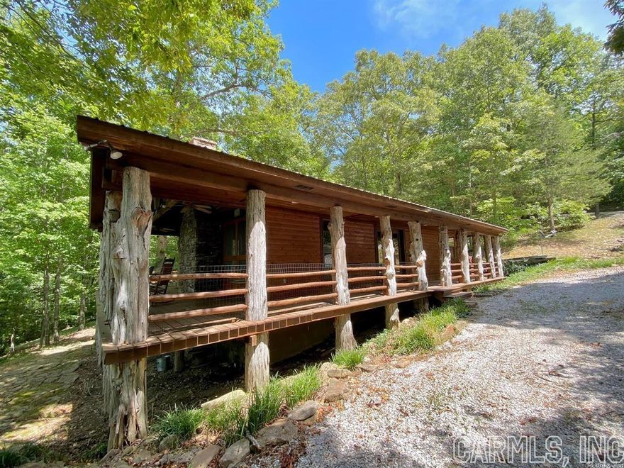 Two lots for a total of 6 acres, detached 24x10 garage, 532' of year-round creek frontage that you see off the back deck, Open kitchen and great room with wood burning fireplace. Vaulted ceilings, wood floors and a metal roof. 95% of all furnishings convey with this property. Gated community for safety and security for when you are out of town. Great permanent home or vacation home