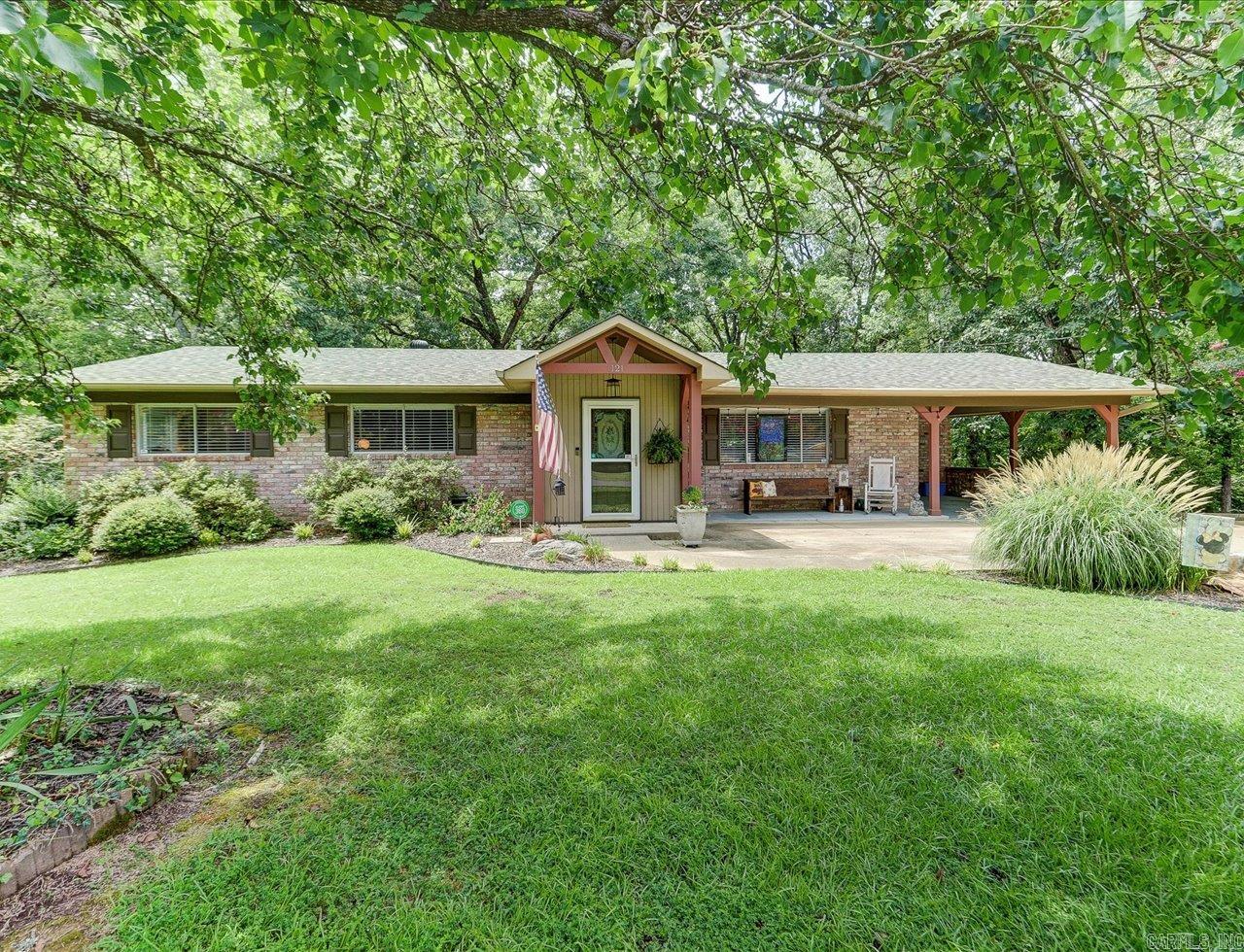 Spacious 5-bedroom, 3-bath home with 3,097 total heated square feet (1,717 sqft upstairs and 1,380 sqft finished downstairs), located just two blocks from Lake Hamilton access. Upstairs includes a bright living room, two dining areas, and a kitchen with stainless steel appliances, double ovens, and brick accents. Three bedrooms are on the main level, including one with an en suite bath. The lower level features a large primary suite with a tray ceiling, oversized walk-in closet, and bathroom with jetted tub and walk-in shower, plus an additional bedroom. Outdoor features include a second-level deck, a covered patio, and a detached storage building that can be used as a workshop, office, or studio. Located on a wooded lot in a quiet neighborhood with seasonal lake views. Agents ā Call ShowingTime to schedule all showings.