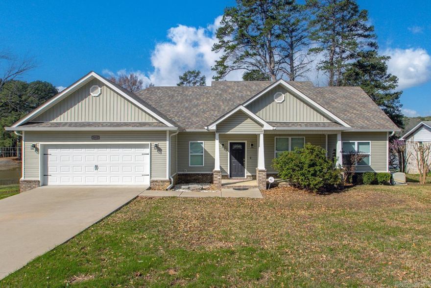 Lake Front - Picture Perfect Home - In The Heart of Benton.... Amenities include: Approximately 2018 square feet, lake front property, 3 bedrooms, 2 bathrooms, open floor plan, split bedroom floorplan, living/dining combo, kitchen/living combo, roomy living room with gas log fireplace, wonderful kitchen with plenty of cabinets, kitchen island with breakfast bar, sunroom overlooking the large backyard and lake front, large primary bedroom, primary bathroom contains walk-in custom tile shower with separate tub, laundry room, luxury final plank throughout home with tile in the wet areas, wood deck overlooking the back yard and lake, laundry room, 2 car garage, large fairly level lot, whole home generator, security system, Bryant Schools, very clean and move in ready home, and much more....  A Must See.....