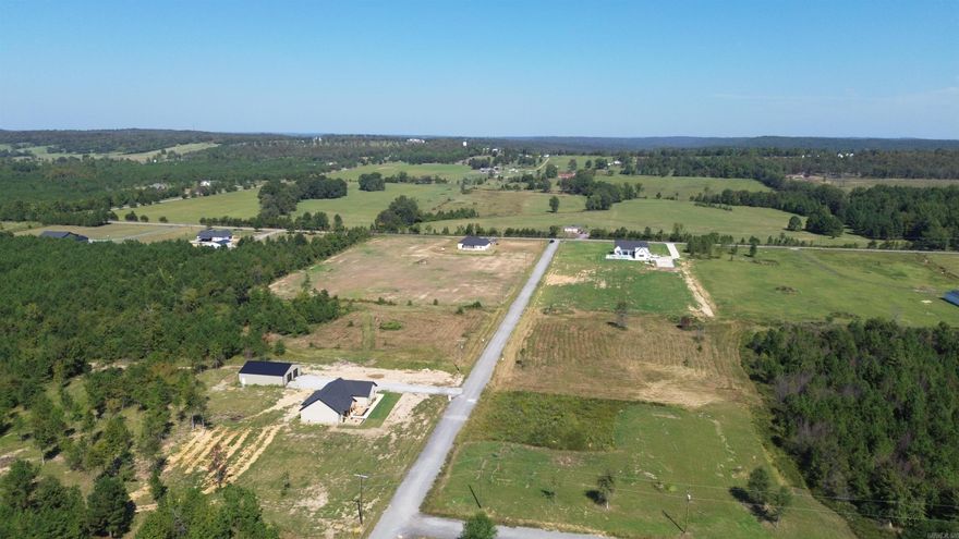 Beautiful flat 6.30+/- acre lot right outside of city limits, perfect spot if you are looking to build! Gorgeous new construction houses are going in all around. Enjoy great views of the countryside in a quiet area while only being a few minutes from the interstate. 20 mins to Vilonia, 20 mins to Searcy, & 20 mins to Cabot. Water and electric are available at the road. No mobile homes. Minimum square footage of 1700.