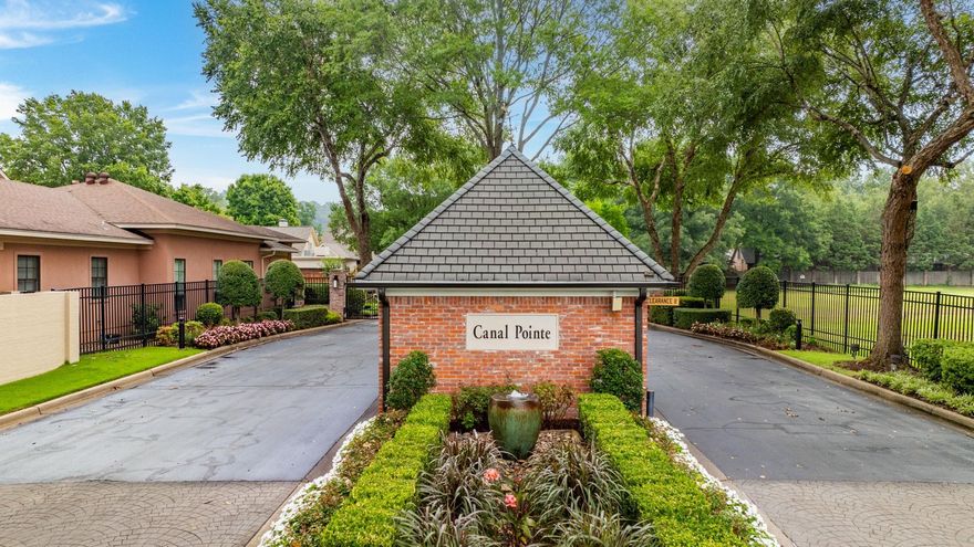 Beautiful patio style home in the wonderful Canal Pointe gated neighborhood.  No stairs to enter this elegant home. A gated courtyard welcomes you to the beautiful double wood front doors. The 2 story living room has a stunning gas log fireplace, gorgeous banister, and an arched case opening leads you into the oversized dining room which overlooks the canal and fenced backyard! Beautiful limestone floors are throughout most of the downstairs. The light filled family room also has a gas log fireplace. The primary bed is on main level with hardwoods, 2 large walk in closets, bathroom with double vanities, tub, & walk-in shower. Many built in drawers & cabinets in the primary bath add to the fabulous storage in this home. The kitchen has quartz countertops, surface gas range, double wall ovens & a walk in pantry. A dry bar is across from the pantry.  Upstairs are 2 very large bedrooms with hardwoods & Jack & Jill bath in between. Also upstairs is an office with bookshelves with carpeted floors. Wine storage and a bonus (heat & cooled) storage room finishes out the upstairs. There is a perfect spot to add an elevator if someone wishes.  Whole house generator as well!  Just beautiful!