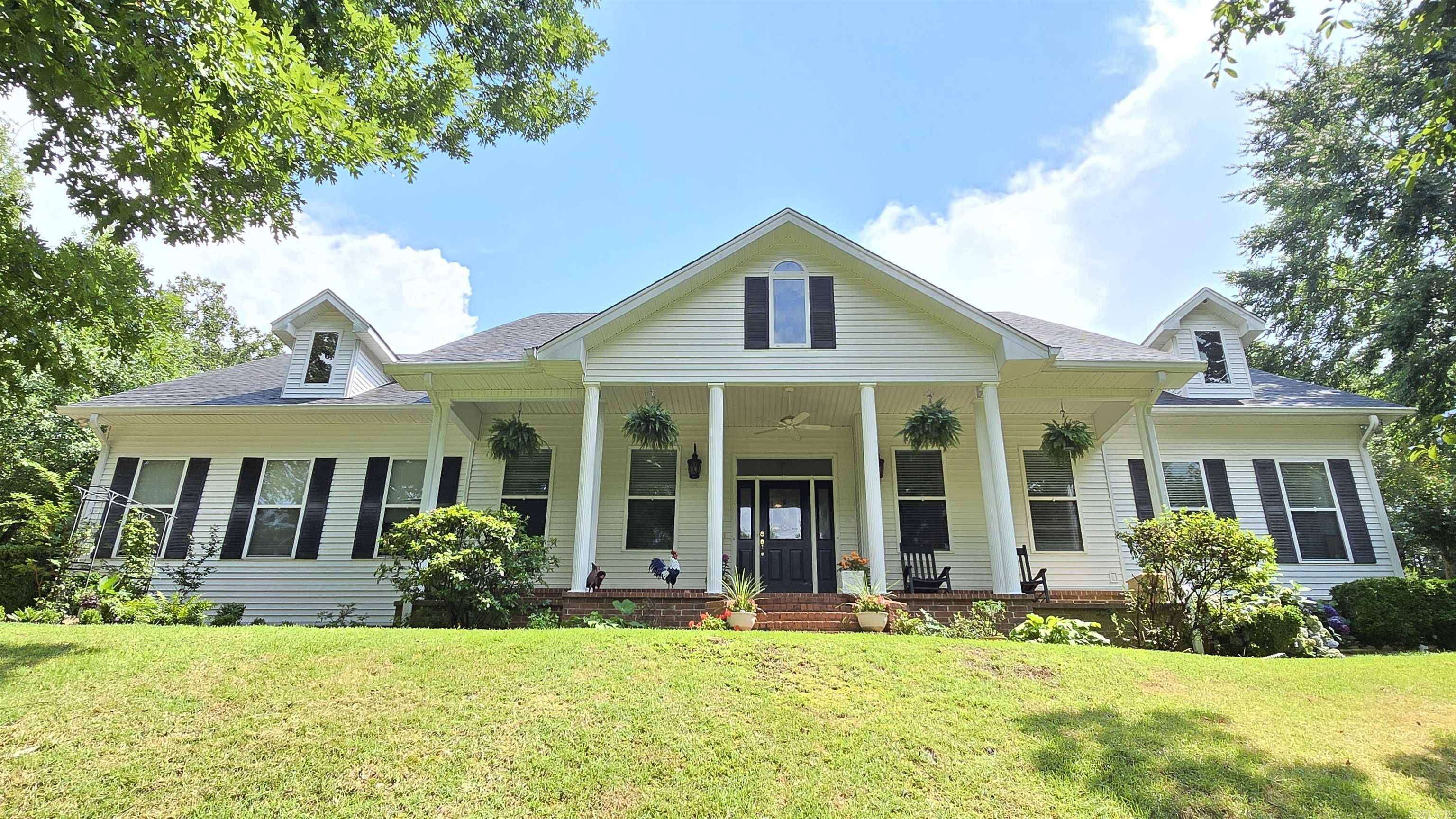 Drive through the peaceful country and take a look at this gorgeous mountain side home with 4 dedicated bedrooms, 3 bathrooms, AND an office nestled on 6.37 private acres just outside city limits. The inside boasts a sweet chef's kitchen with stainless steel gas stove, double oven, and refrigerator that conveys, the also includes 2 tankless water heaters, a wood burning fireplace with gas starter, and 3 all newly updated bathrooms with new paint and granite counter tops. The master bedroom and bathroom are separated, the guest bedroom has its own full bathroom, and another two bedrooms share a full bathroom. The outside is a homesteader's dream with 2 chicken coops, a 10x20 greenhouse and fenced off gardening area full of growing fruits, vegetables and herbs. The home also has 2-500 gallon rain colection points, a 22kw home generator, storm shelter in the 2-car garage, 2-500 gallon propane tanks, a new roof in 2022, and a new water filtration system with robust water softener. This house could be your peace and serenity and the sellers are motivated, so schedule your showing today! Agents, please see remarks.