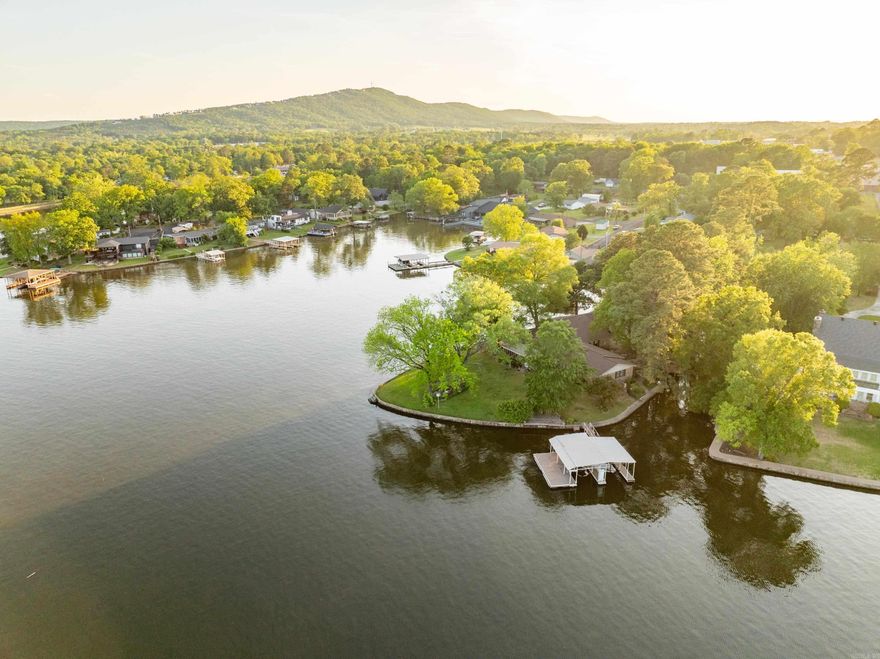 A Rare Opportunity to Own One of the Last Point Properties on Lake Hamilton Nestled on a premium peninsula, this exceptional propertyboasts over 465 feet of prime shoreline on coveted Lake Hamilton, offering unparalleled water frontage and panoramic lake views. Thisis more than just a home—it’s a once-in-a-lifetime opportunity to own a truly unique piece of real estate where the value lies in itsextraordinary land. With over 465 feet of lake frontage, this expansive property is perfectly positioned to capture 180-degree vistas ofserene waters, vibrant sunsets, and natural beauty in every direction. The point location offers privacy, tranquility, and unobstructedviews that are simply unmatched. Whether you choose to renovate, expand, or reimagine this property entirely, the possibilities are asendless as the views.