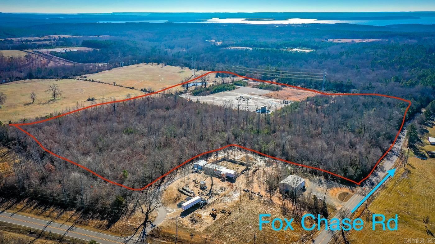 27.99 acres +/- with a great location close to the town of Greers Ferry, outside of the city limits & right behind the new DG Market. The acreage has a nice long stretch of road frontage on Fox Chase Rd. (which is a county maintained road), plus the property touches one of Greers Ferry's Volunteer Fire department locations. There is approximately 20 acres +/- of woods & approximately 7 acres +/- cleared where the Flywheel Gas Pad is located. Mineral rights do not convey (Seller owns 50% of the mineral rights). This property is unrestricted & there were a couple of creeks running after this last rain. There has not been a survey drawing done on this property that we know of.