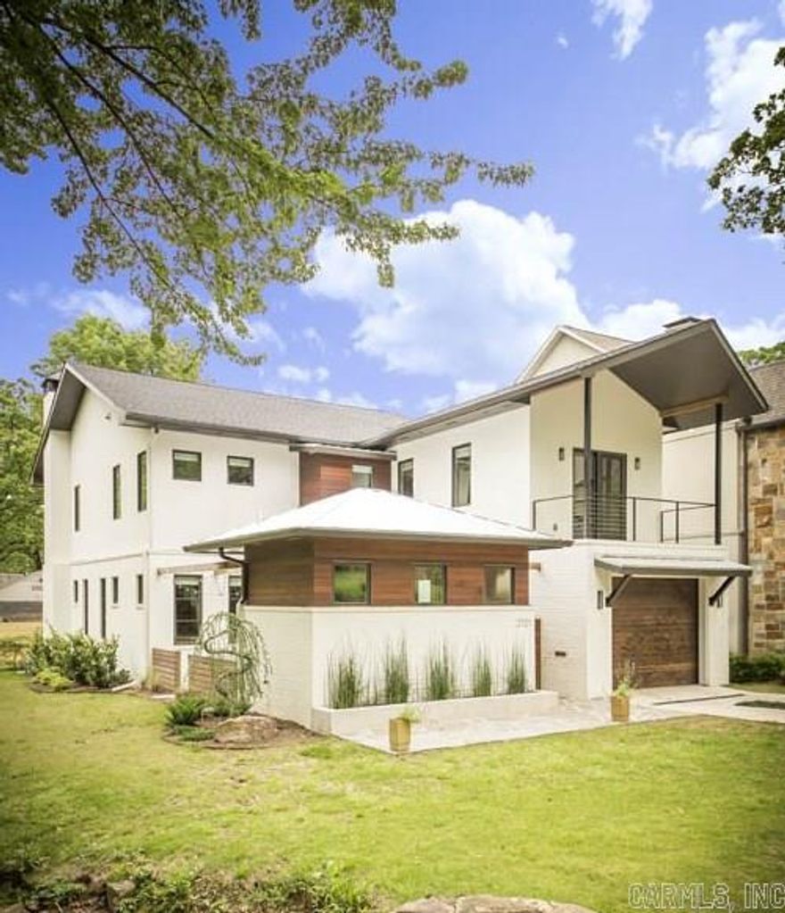 Urban chic in the Heights! New design and build by Dwellings, Inc.  Featured in June's issue of AT HOME in Arkansas.  Warm contemporary home with exposed brick inside, antique hand hewn beams, concrete and wood floors, Carrera marble and stainless counters in kitchen. WB fireplace inside and outside on covered patio. 2 car tandem garage.  Fabulous indoor & outdoor living which is perfect for entertaining.  Many areas of creative unique storage and too many extras to list! A MUST SEE!!!!