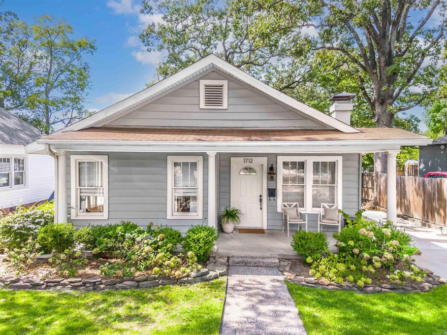 Charming bungalow a few steps away from the Heights! This move-in ready Two bed, Two bath home features an open floor plan with two living areas, a cozy wood-burning fireplace, and a versatile laundry/bonus space. The recently updated kitchen boasts granite countertops and stylish finishes, while the freshly renovated guest bathroom and beautiful window treatments add modern touches throughout. The spacious primary suite offers a walk-in closet and private en-suite, and the fenced, level backyard with a large deck is perfect for entertaining. A covered front porch adds curb appeal, and parking is a breeze with rear alley access, parking pads in front, and additional off-street options. Just steps from the Heights’ shops and restaurants and minutes to midtown, this home blends comfort, convenience, and classic bungalow charm. Agents see Remarks*