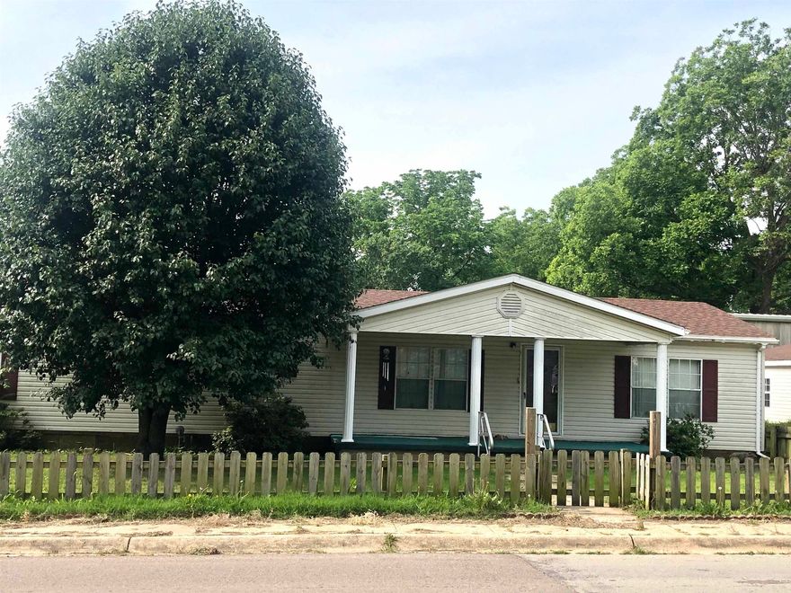 This spacious manufactured home offers 1,617 square feet of comfortable living space, featuring three bedrooms and two full bathrooms. The split floor plan enhances privacy, with the primary suite separated from the other bedrooms. The open-concept living area flows seamlessly into a large kitchen, perfect for entertaining or family gatherings, and includes a cozy fireplace for added warmth and charm. An additional sunroom provides a bright, flexible space that can be used year-round. Outside, a detached two-car garage offers convenient storage and parking. For added utility, a 30x40 steel shop provides plenty of room for hobbies, storage, or a workspace, making this property ideal for those who need extra room for projects or equipment. This property is well-suited for anyone looking for a blend of space, functionality, and comfort.