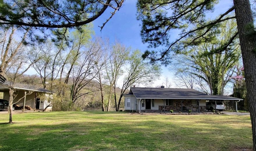 There’s something grounding about living on the White River—the quiet mornings, the sound of moving water, and the sense of escape it brings. This 2-story riverfront home w/carport offers not just space, but the potential to create your own riverside experience. The main level features 2 bedrooms/1 full bath, and a welcoming kitchen/dining combo. Downstairs, the fully heated/cooled walk-out basement includes 2 additional bedrooms, a full bath, and a kitchenette—ideal for guests, multi-generational living, or continued short-term rental use. Interior access connects both levels, while the lower patio opens to the natural setting beyond. Evenings are best spent by the wood-burning fireplace or outside on the porch or patio, taking in the peaceful surroundings. The property includes a detached 2-car carport w/storage and sits on approximately 0.70 acres with a mix of level and sloped terrain. While the riverbank is not a gradual walk-down, the setting offers the opportunity to create easier access to the bank of the White River, allowing future owners to shape the river lifestyle they envision. Located just outside Mountain View with paved road access. No HOA. Shown by Appointment.