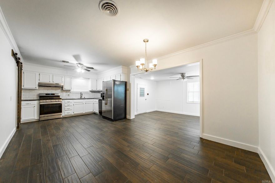 Welcome to this charming 3 bedroom, 1.5 bath home offering fresh updates and plenty of space! Inside you’ll find newly painted interiors that create a light and inviting atmosphere, complemented by durable flooring throughout. The kitchen features a natural gas stove, stainless steel appliances, white cabinetry, and a stylish subway tile backsplash, opening to a dining area perfect for family meals. The living spaces are generous, including a bright sunroom that adds extra flexibility for a home office, playroom, or cozy retreat. The oversized primary bedroom offers its own half bath for convenience, while the additional bedrooms share a refreshed full bath with modern finishes. Step outside to a large backyard featuring mature trees, a fenced-in area, and an impressive workshop—ideal for hobbies, storage, or a home business. With a covered carport, new HVAC installed in 2024, and thoughtful updates throughout, this home combines comfort, functionality, and value. Move-in ready and waiting for its next owner!