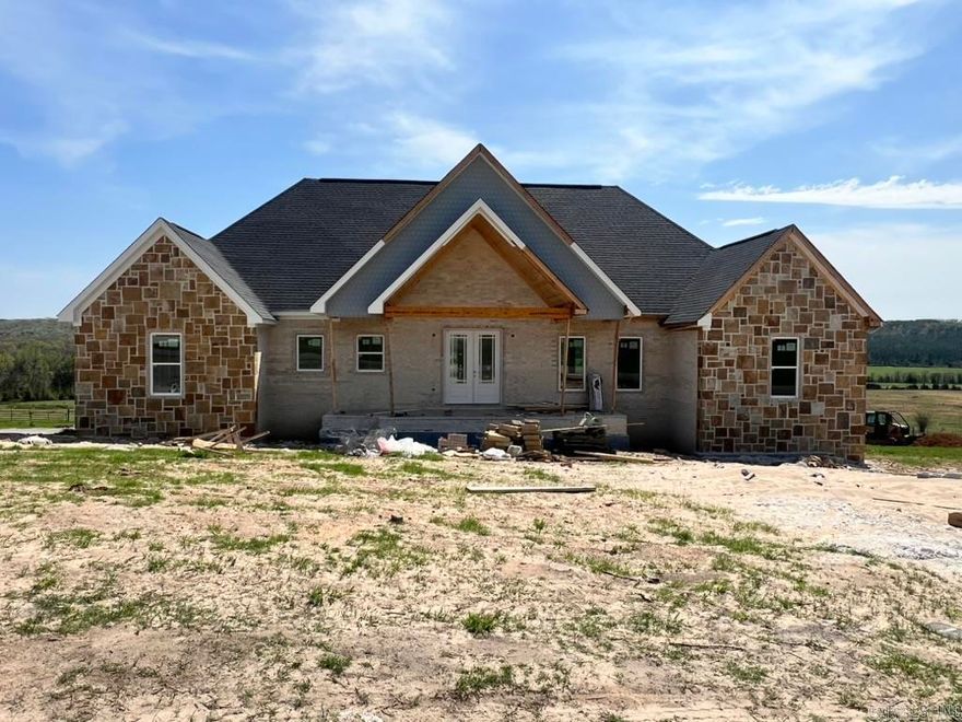 This custom-built new construction home sits on a spacious 1.12-acre lot in Greenbrier and offers 2,228 sq ft with 4 BR, 3 BA, including a Jack-and-Jill and a luxurious primary suite with a soaker tub and walk-in tiled shower. The open layout features vaulted ceilings with wood beams in the living area and primary bedroom, LVP flooring throughout, quartz countertops, and a gas log fireplace. The kitchen boasts stainless steel appliances, a hidden walk-in pantry, and custom cabinetry. Additional highlights include a laundry room with sink, mudroom, covered back patio, and enclosed rear storage area. Gas appliances include the range, fireplace, and tankless water heater.  Lots of extras, its a must see. Agent see remarks.