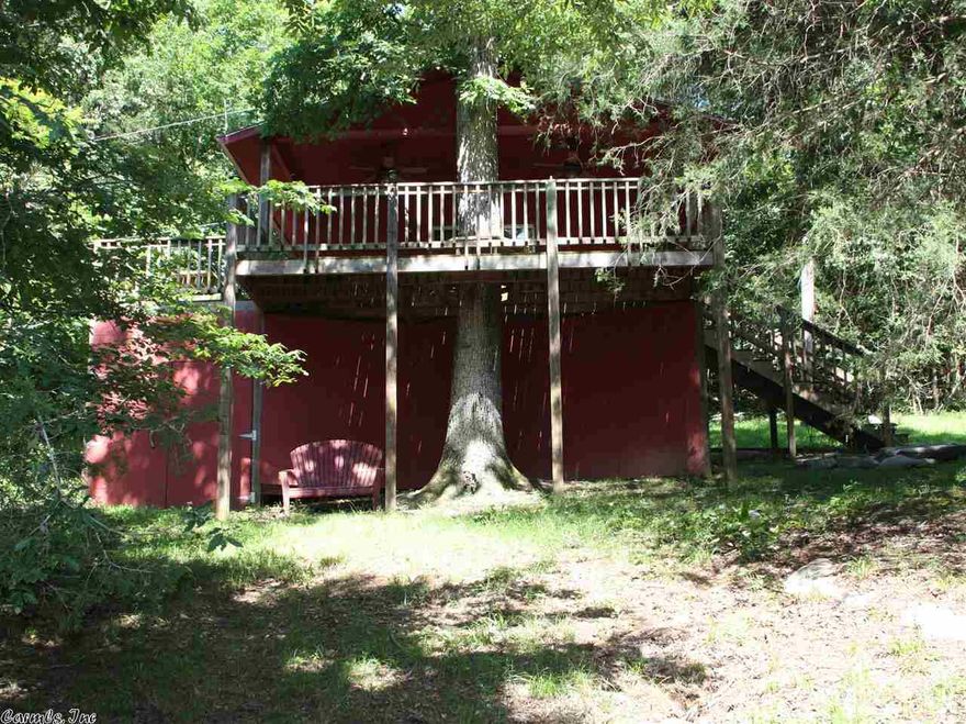 This rustic cabin has an open kitchen/dining/living room area and a bath w/shower. A spacious 16x20 covered front deck continuing around the side to a sunny 26x8 deck, perfect for entertaining. The front deck has a tree surrounded by benches providing an interesting treehouse effect and plentiful shade. Furnishings are included.  A large storage space at ground level under the deck. Tranquil and relaxing, a short walk to south Sylamore Creek. A great getaway for enjoying nature and short drive to Mt. View.