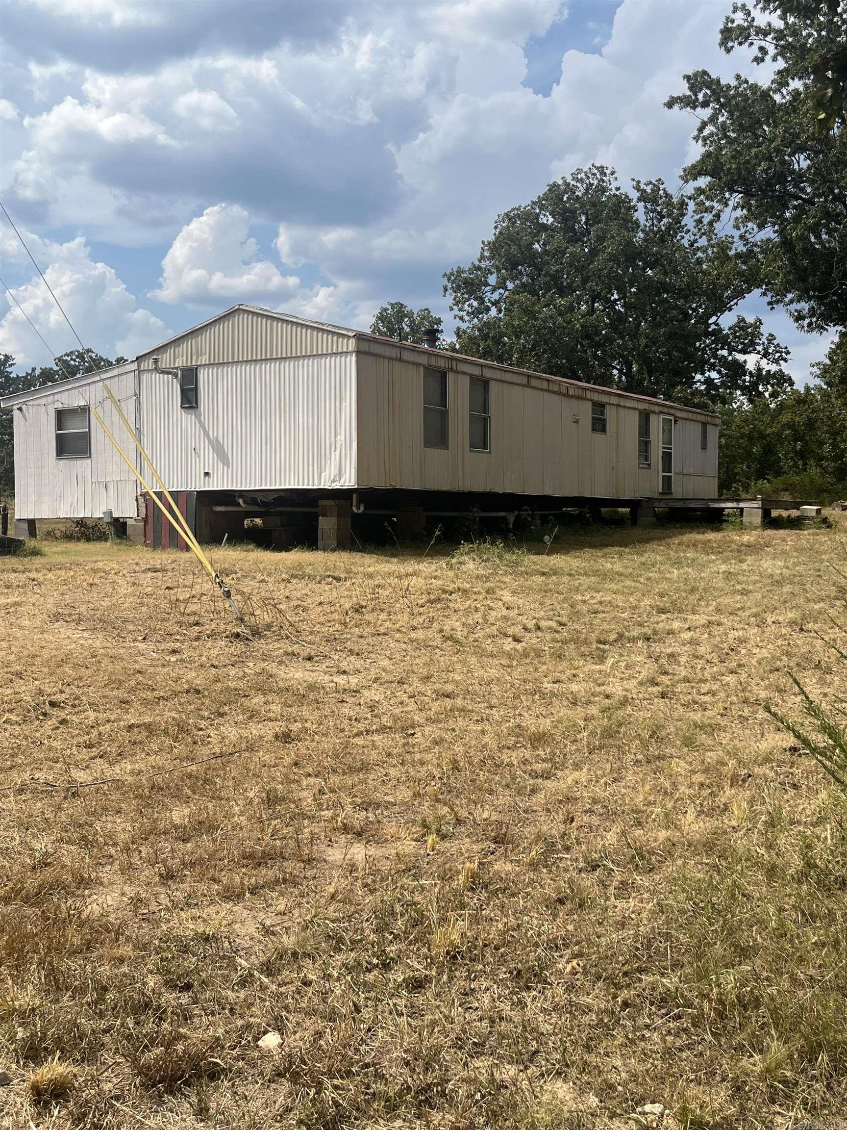 15 acres!!!! Perfect spot for a beginning homesteader or to build your dream home. This property is situated perfectly between Mammoth Spring and Salem. The land lays great and the perfect mix of woods and clearing. Property is fenced completely and already has an established garden area that is high fenced to keep the deer out. There is an old chicken coup and pen area. The trailer was recently replumbed with pex water lines and new drain lines. Working well to support the livestock. There are 2 beds and 1 full bath in the trailer as well as the addition that has 2 more bedrooms and an additional living area. Trailer does need some tlc but could make a great home or deer camp. Seller installed a new storm cellar earlier this Spring. There is an abundance of wildlife in the area. Next fiberoptic internet is already in place. The portable carport will remain with the property.