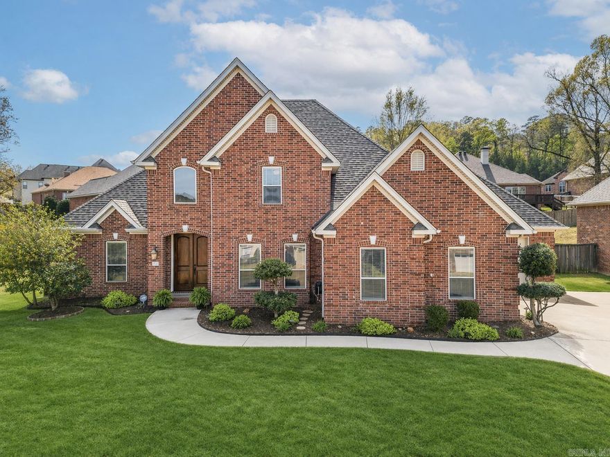 Beautiful custom-built home in Maumelle Valley Estates, originally built by the builder for his personal residence and purchased prior to occupancy—reflecting quality craftsmanship and thoughtful design. This well-maintained home offers 4 bedrooms and 3.5 baths, including two primary suites—one on the main level and a second upstairs with its own dedicated private bath. The spacious living area features custom built-ins surrounding a gas-log fireplace. Hardwood flooring enhances the grand foyer with custom chandelier and staircase, flowing into the formal dining area. The kitchen offers an island, maple cabinetry with glass accents, granite countertops, and stainless steel appliances. A private office with glass French doors is located just off the breakfast area. Upstairs includes the second primary suite with dedicated bath, two generously sized guest bedrooms, and a separate guest bath with dual vanities. A 3-car garage, front and back sprinkler system, French drains, and a 6-year-old roof complete the home. Enjoy outdoor living with a covered patio, extended flagstone patio, and additional seating area perfect for relaxing or a fire pit area.  Immaculate Condition!