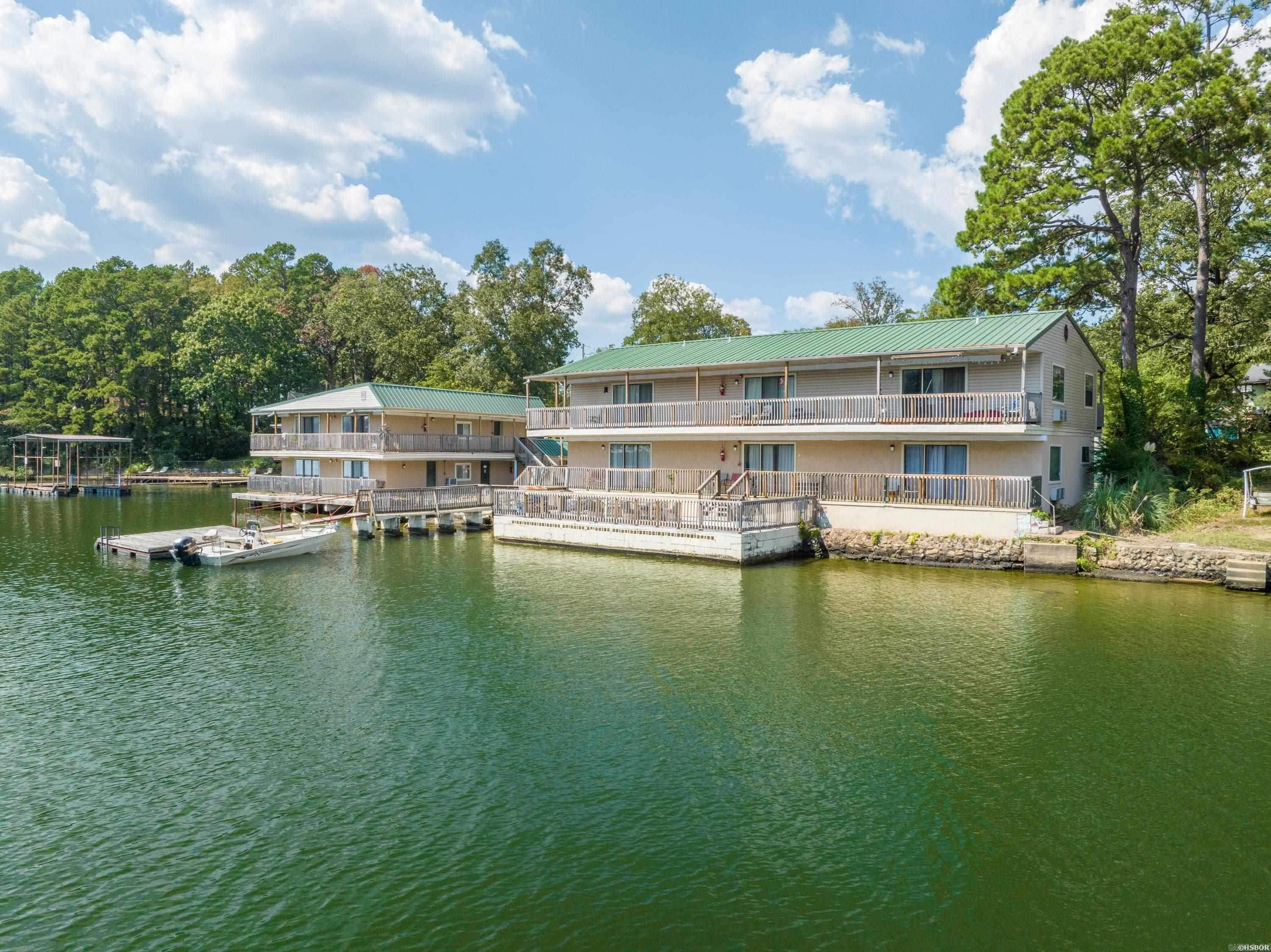 Very rare opportunity to own a 14 unit motel on Lake Hamilton! This one acre lake property boasts 14 charming rental units, along with a unique, historic home built in 1898! This former apartment complex has been totally revamped into a charming short term rental complex. The current owner has made lots of updates throughout the property to meet current short term rental codes. STR permits have been obtained for each of the units. A brand new fire suppression system has been installed throughout the facility. The property has private boat ramp, and Entergy may approve construction of additional boat slips. There is potential to add lots of additional value by converting all of the units to Airbnbs, remodeling the home and/or constructing additional rental units on the property.