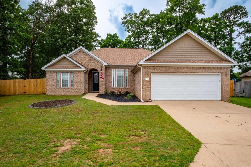 Welcome home to Hollow Bend. Tucked away on a quiet drive with charming curb appeal, this 3-bedroom, 2-bathroom home is ready for its next owners. A large entry opens into a comfortable living room and formal dining area, featuring a gas-start fireplace and views of the backyard. All new luxury vinyl plank flooring throughout. The kitchen is designed for efficiency with plenty of cabinetry, a pantry, and a sunny breakfast nook for casual meals. The split floor plan ensures privacy, placing the primary suite in the back corner of the home with its own bath and walk-in closet. Finish your day on the covered back patio overlooking a large, fenced-in yard.