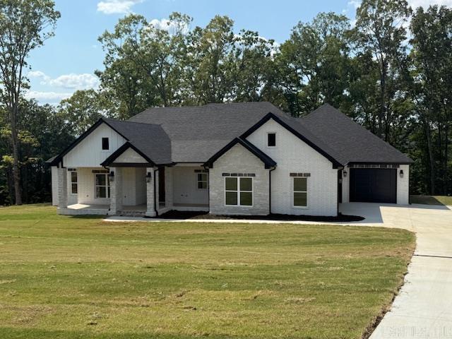 Over one acre Lakefront Lot! Enjoy the views of the lake from the big covered back porch with a vaulted tongue & groove wood ceiling. A large deck will be added for even more outdoor entertaining space. There will be room in this backyard if you wanted to add a pool later. The home is open concept with cabinets in the kitchen to the 10 ft. ceilings. The pantry is huge & will be hidden behind the cabinet doors in the kitchen cabinets. Will have a massive island with the sink in the island. The living room has a vaulted ceiling that carries out to the back porch. You will love the windows with the views of the lake. The laundry is oversized with lots of cabinets. From the laundry room you can enter the primary closet with more room than you will have clothes for. From the closet you can enter the primary bathroom. Separate tile shower & soaking tub and dual vanities. Primary bedroom is separate from the 3 guest bedrooms. Luxury vinyl flooring throughout. Lockers as you come in from the garage. The 3rd bay of the garage is extra deep (35 feet) to stow all of your lake toys and your boat. There is also room on this lot to build a shop. This subdivision is brand new. All new homes here